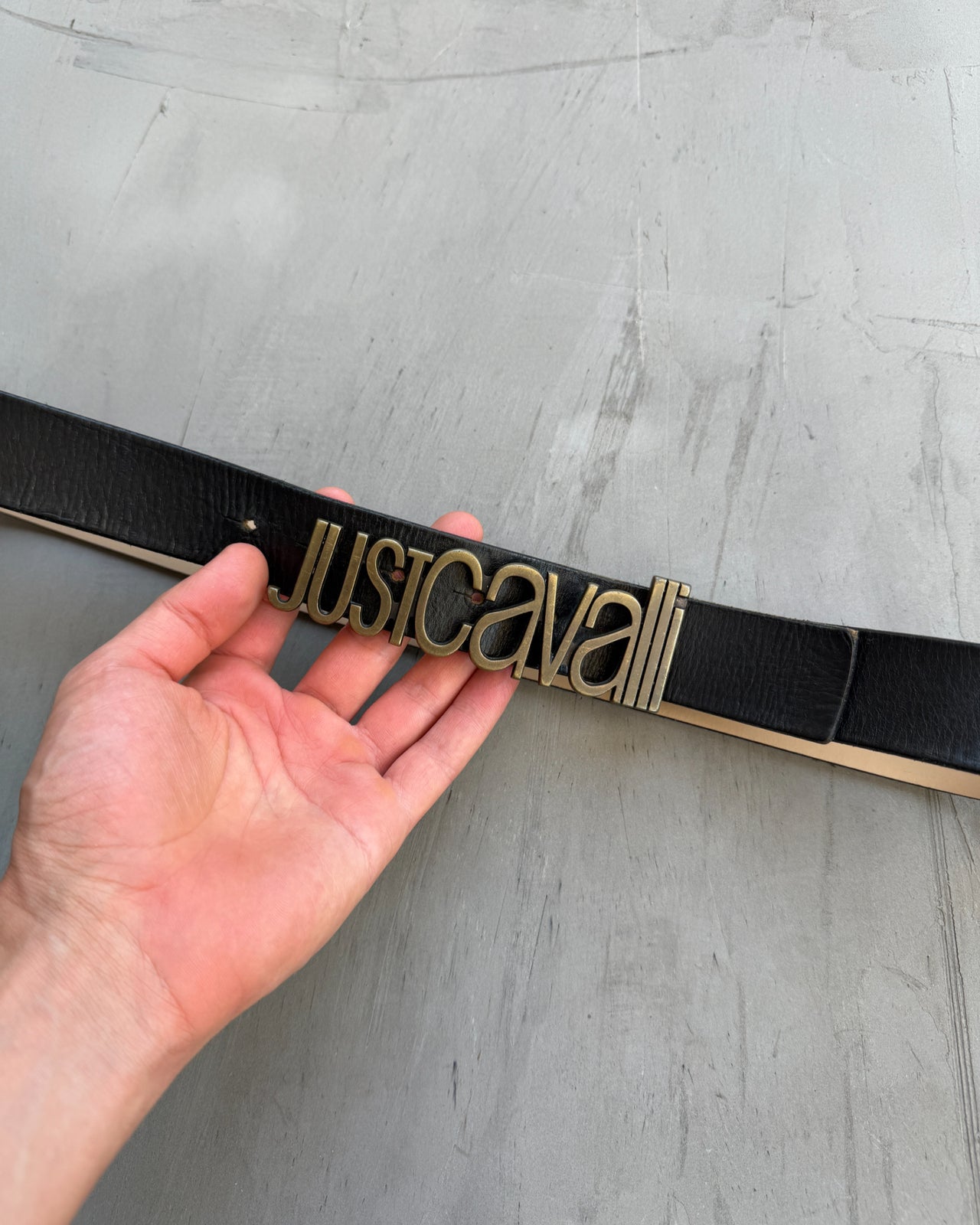Just Cavalli Black Leather Belt-on a concrete background