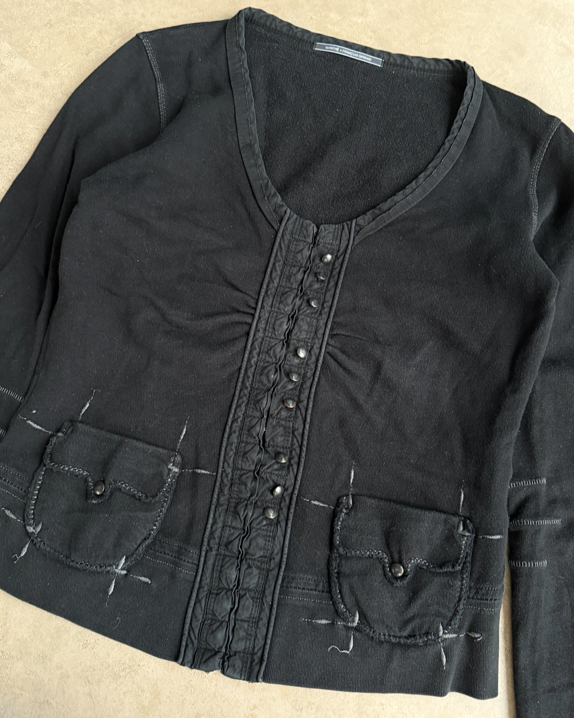 Marithé + François Girbaud Cotton Hoodie – M-on a concrete background