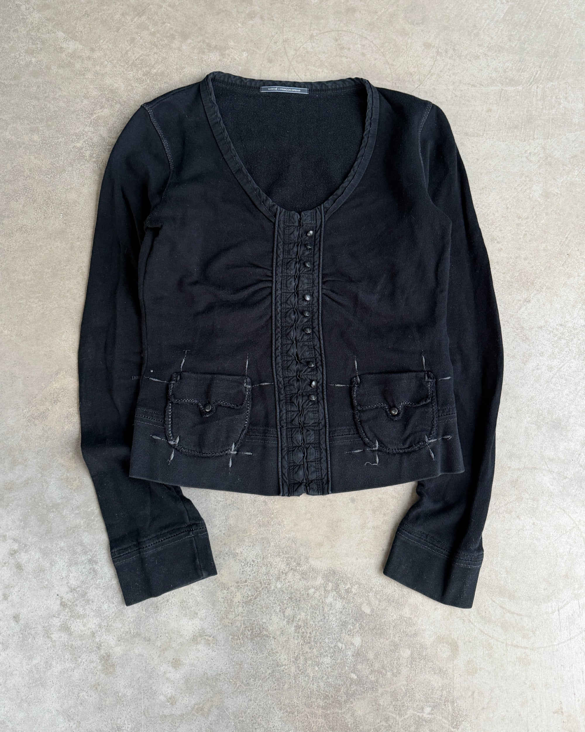 Marithé + François Girbaud Cotton Hoodie – M-on a concrete background