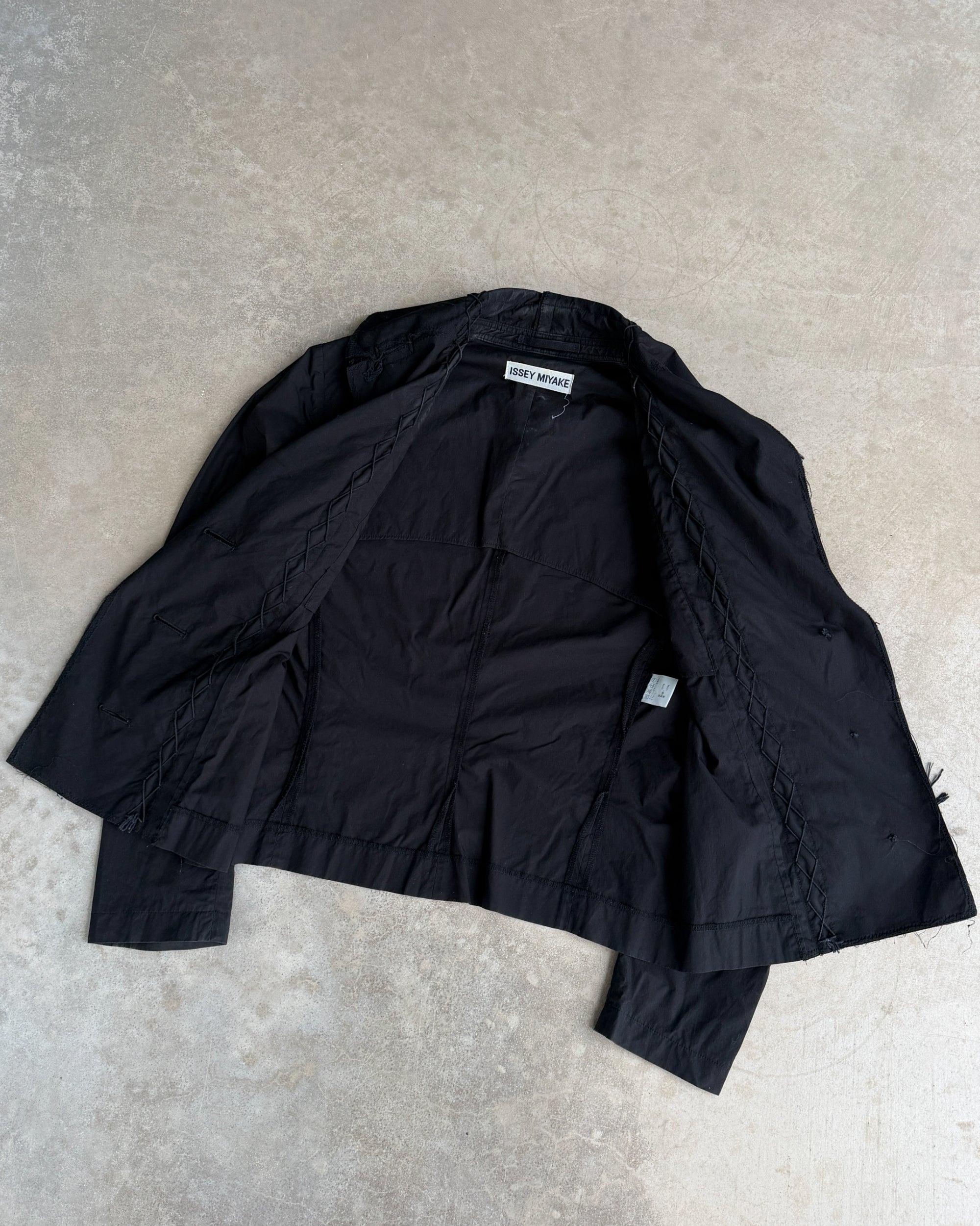 Issey Miyake SS03 Distressed Cotton Jacket – M-on a concrete background
