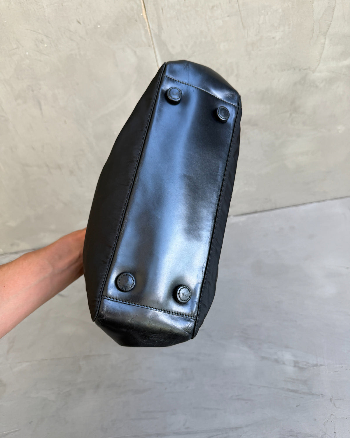 Prada Black Nylon and Leather Shoulder Bag-on a concrete background