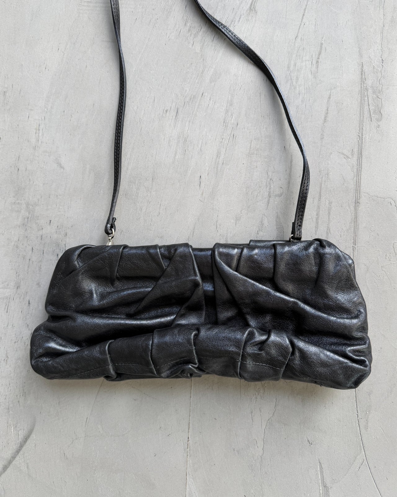 Giorgio Armani Pleated Leather Clutch Bag-on a concrete background