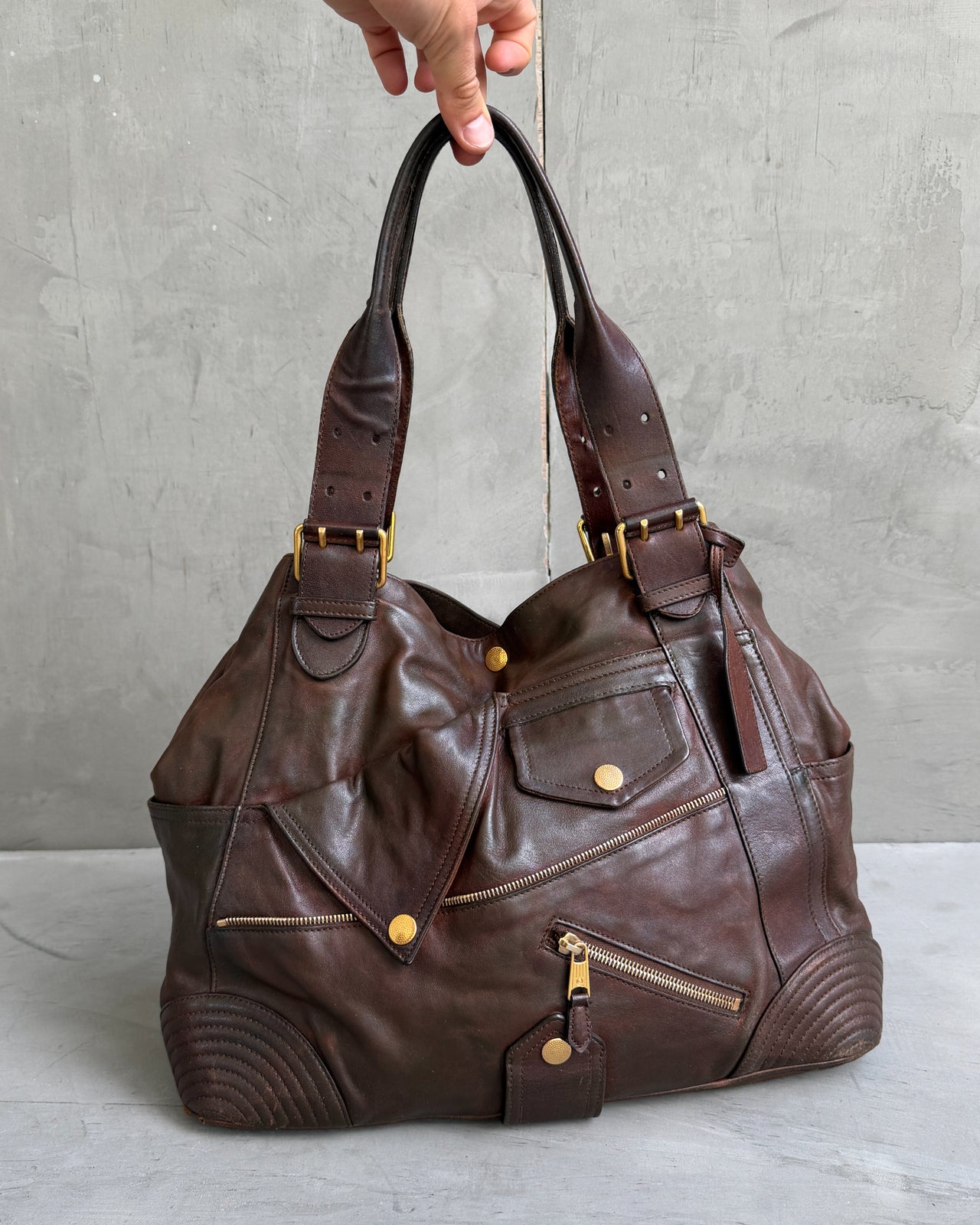 Alexander McQueen Faithful Multipocket Leather Shoulder Bag-on a concrete background