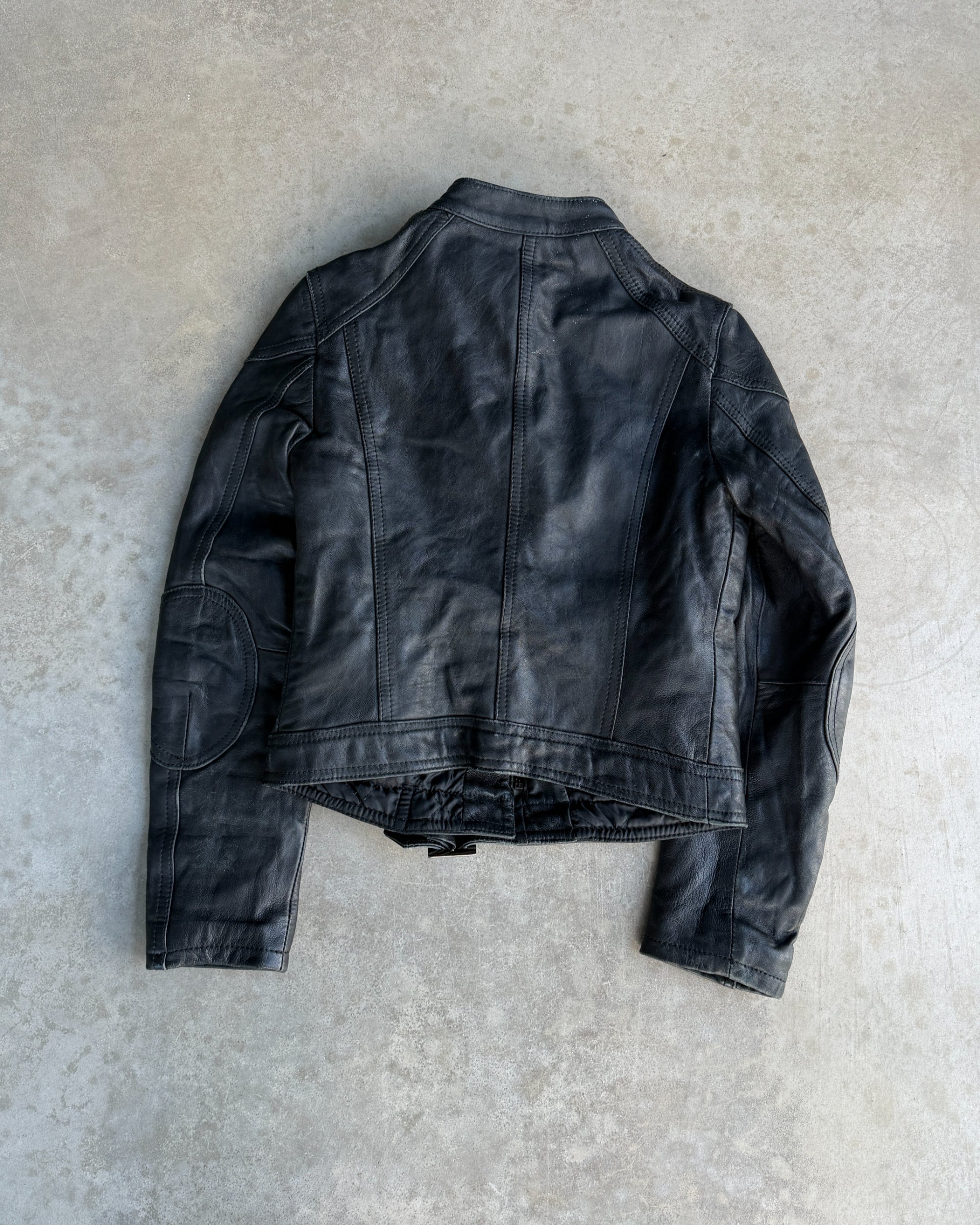 Italian Black Leather Multi-Pocket Jacket – S-on a concrete background