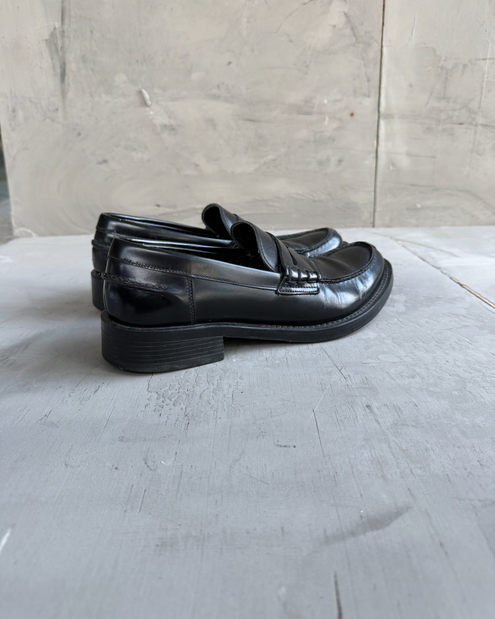 Miu Miu Black Leather Loafers – EU 40-on a concrete background