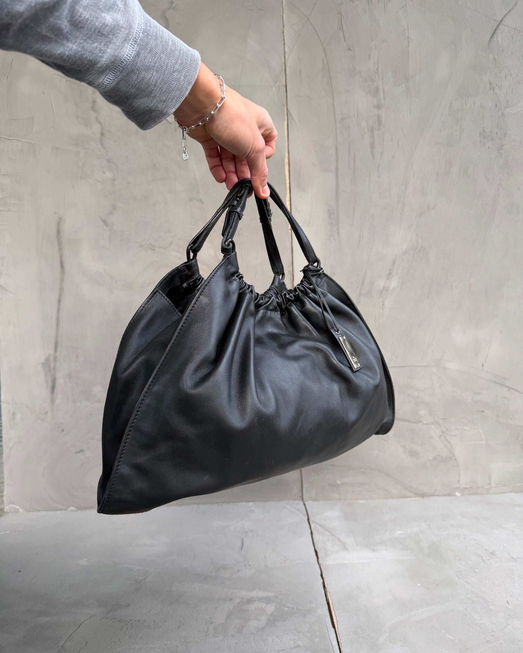 Gucci by Tom Ford Ruched Leather Shoulder Bag-on a concrete background