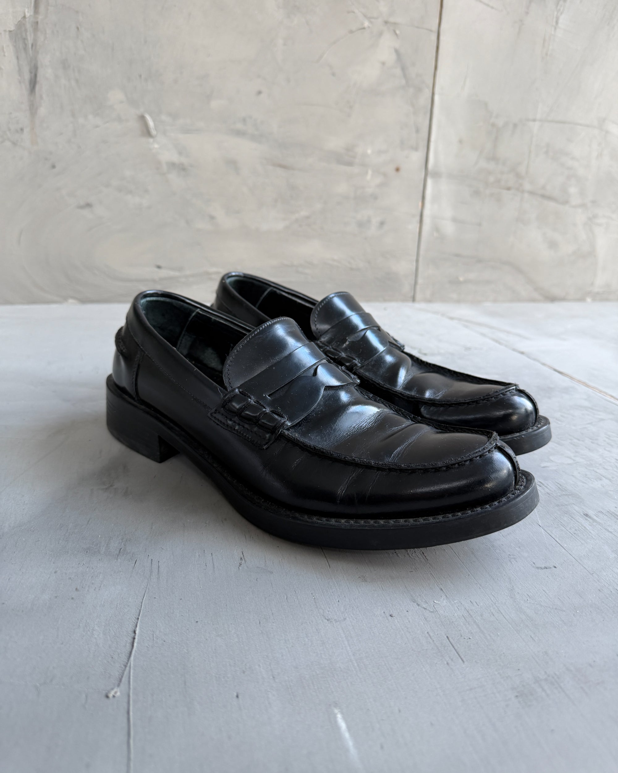 Miu Miu Black Leather Loafers – EU 40-on a concrete background