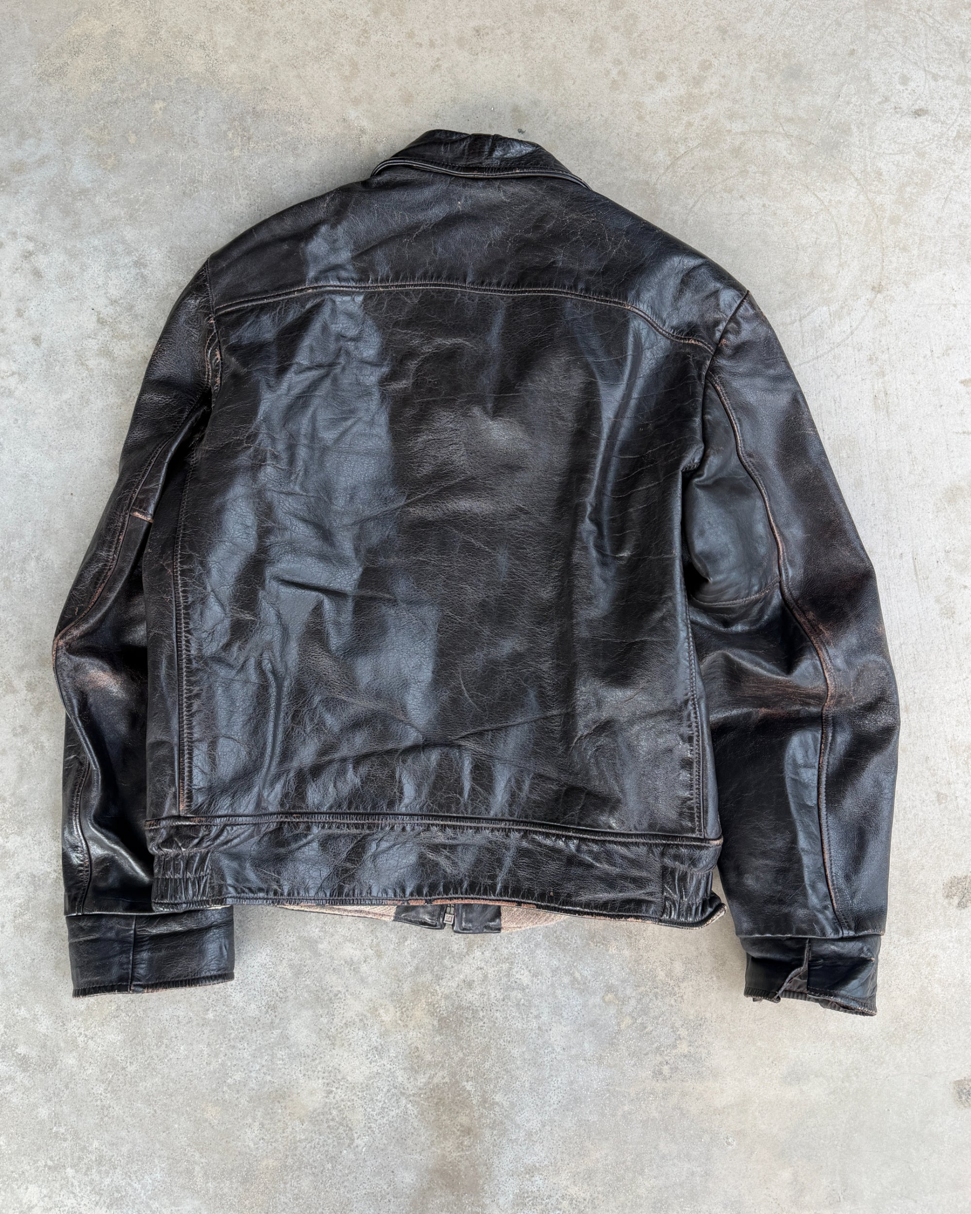 1970s Vintage Leather Jacket with Wool Lining – S-on a concrete background