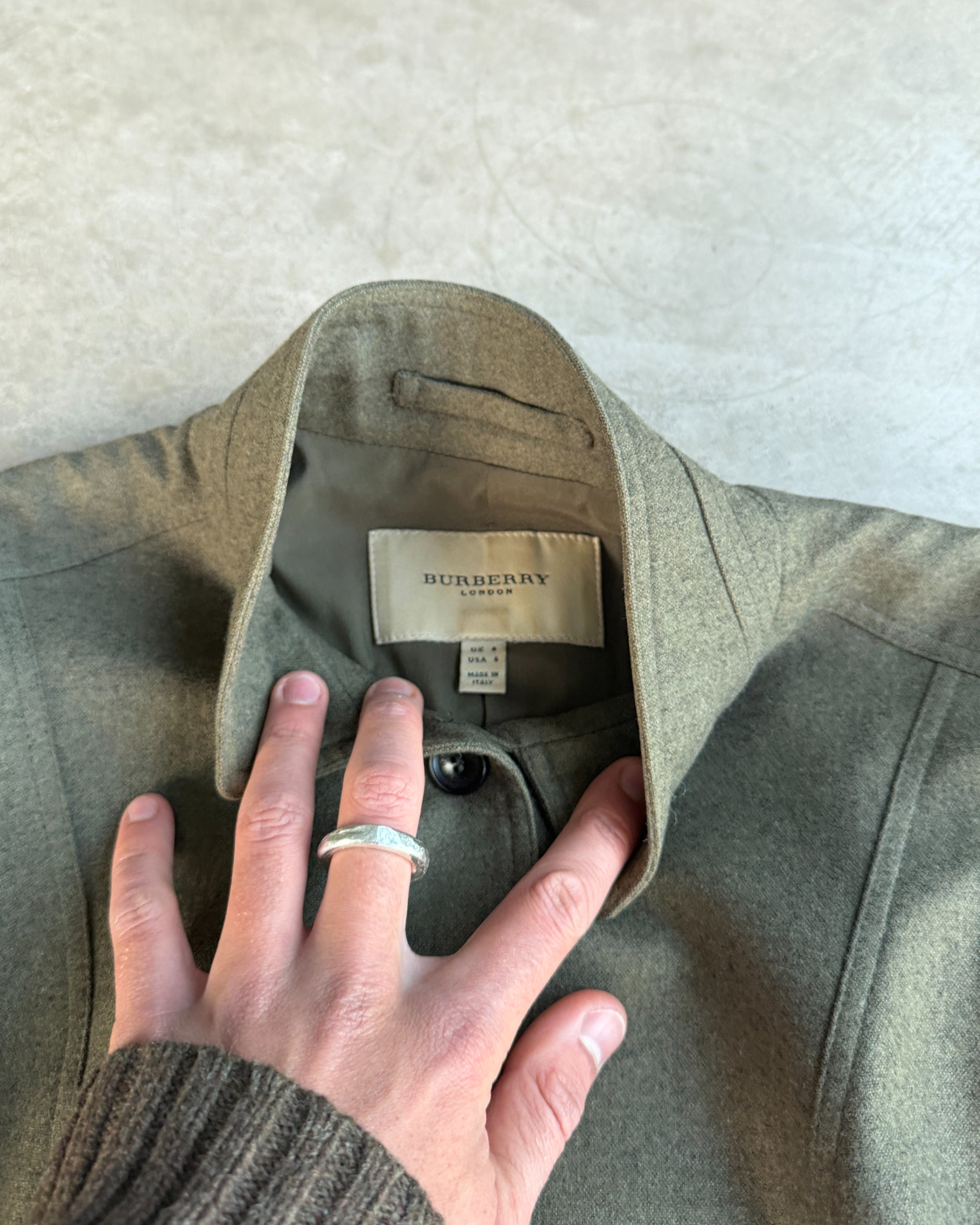 Burberry Wool and Cashmere Military Jacket – S-on a concrete background