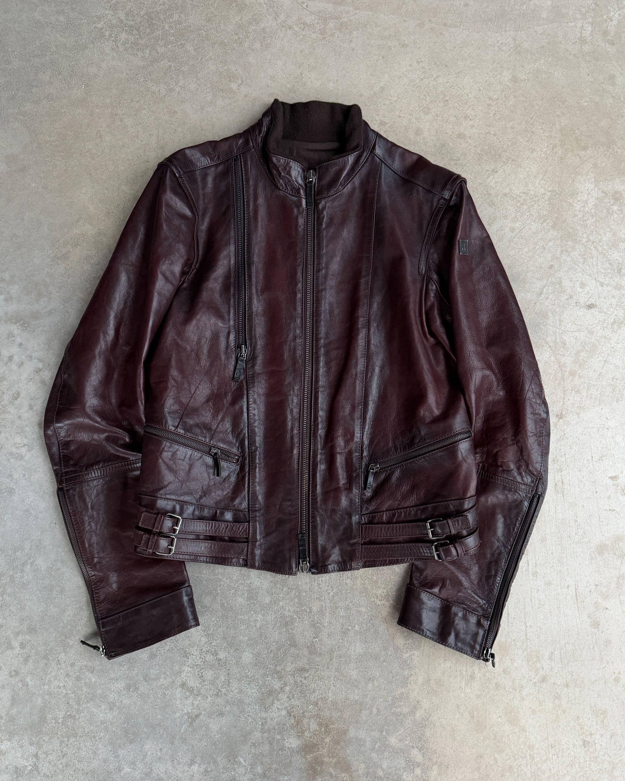 Calvin Klein Buckle Leather Jacket – M-on a concrete background