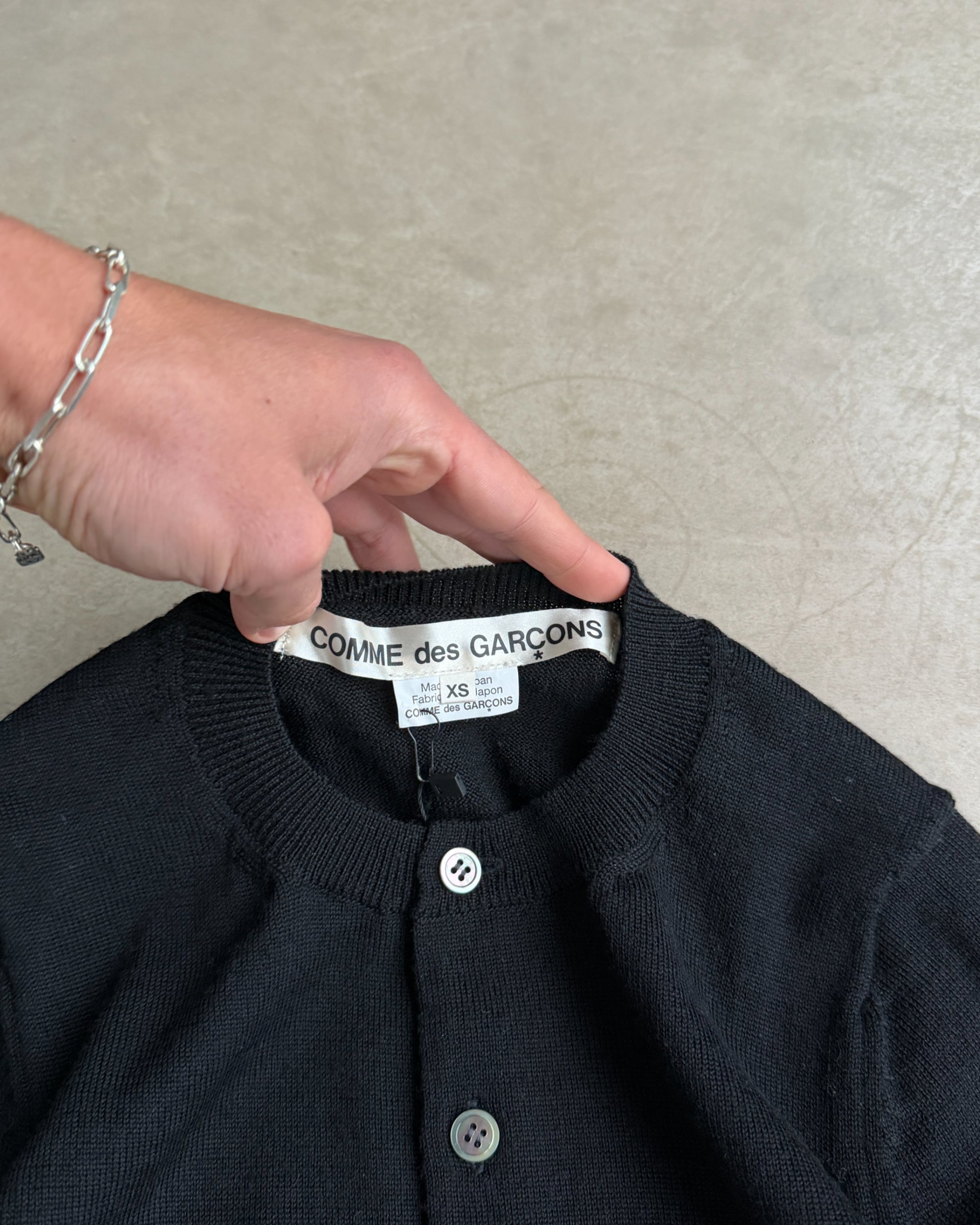 Comme des Garçons 2015 Wool Cardigan – XS-on a concrete background