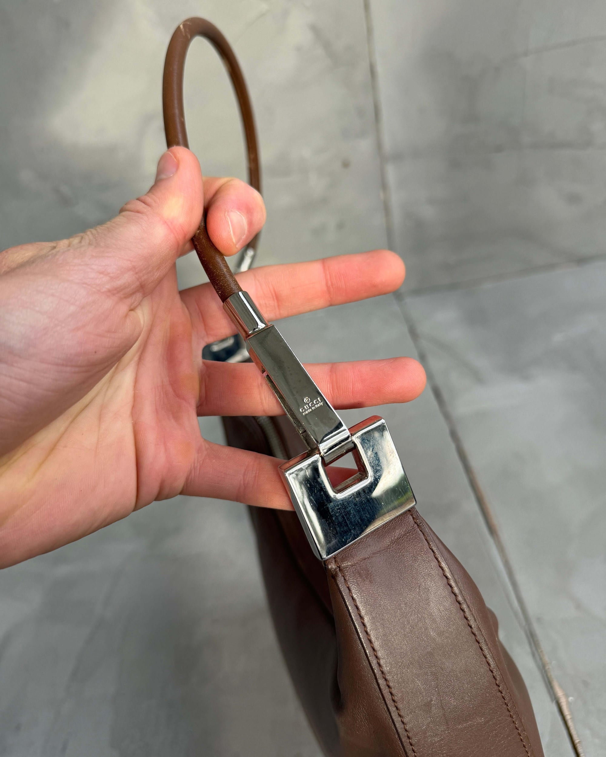 Gucci Asymmetric Structured Leather Shoulder Bag-on a concrete background