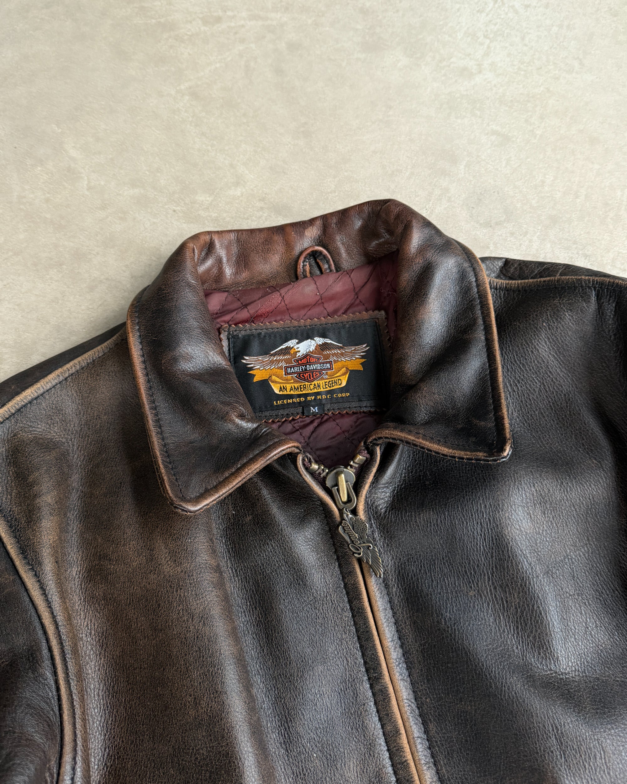 Harley Davidson 1990s Leather Jacket – M-on a concrete background