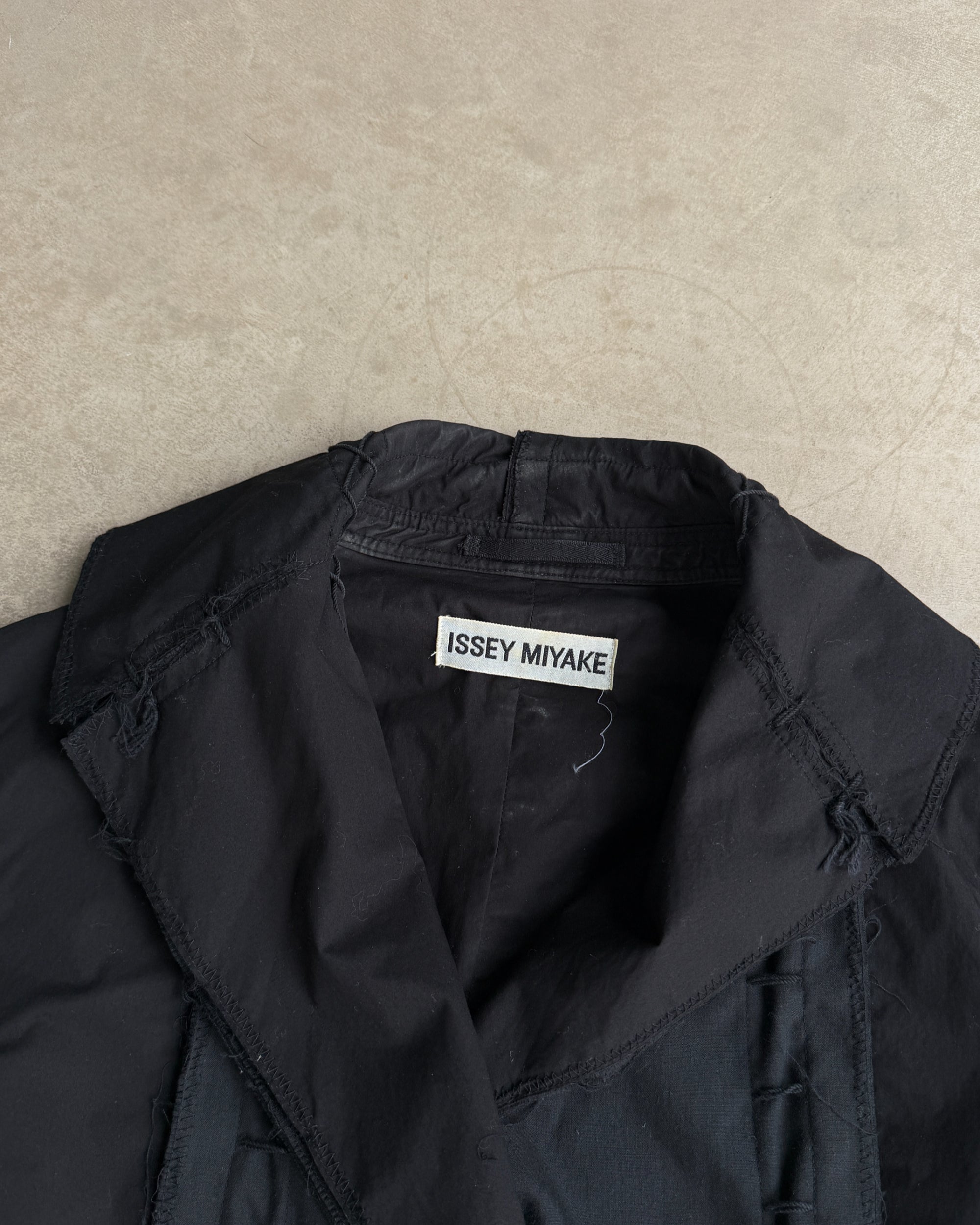 Issey Miyake SS03 Distressed Cotton Jacket – M-on a concrete background