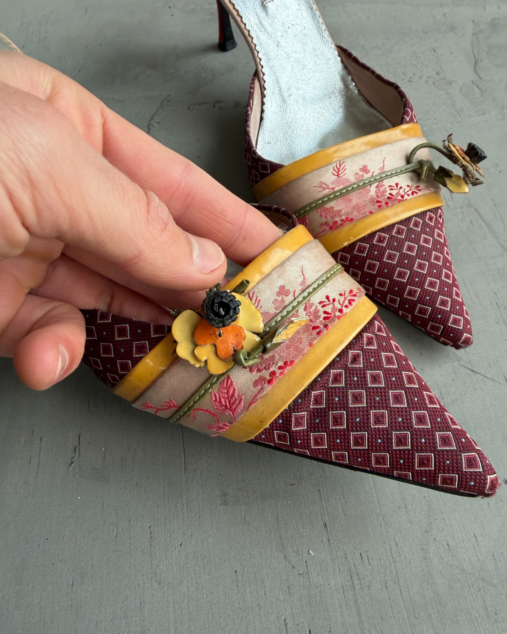 Prada Silk Embellished Kitten Heels – EU 37.5-on a concrete background