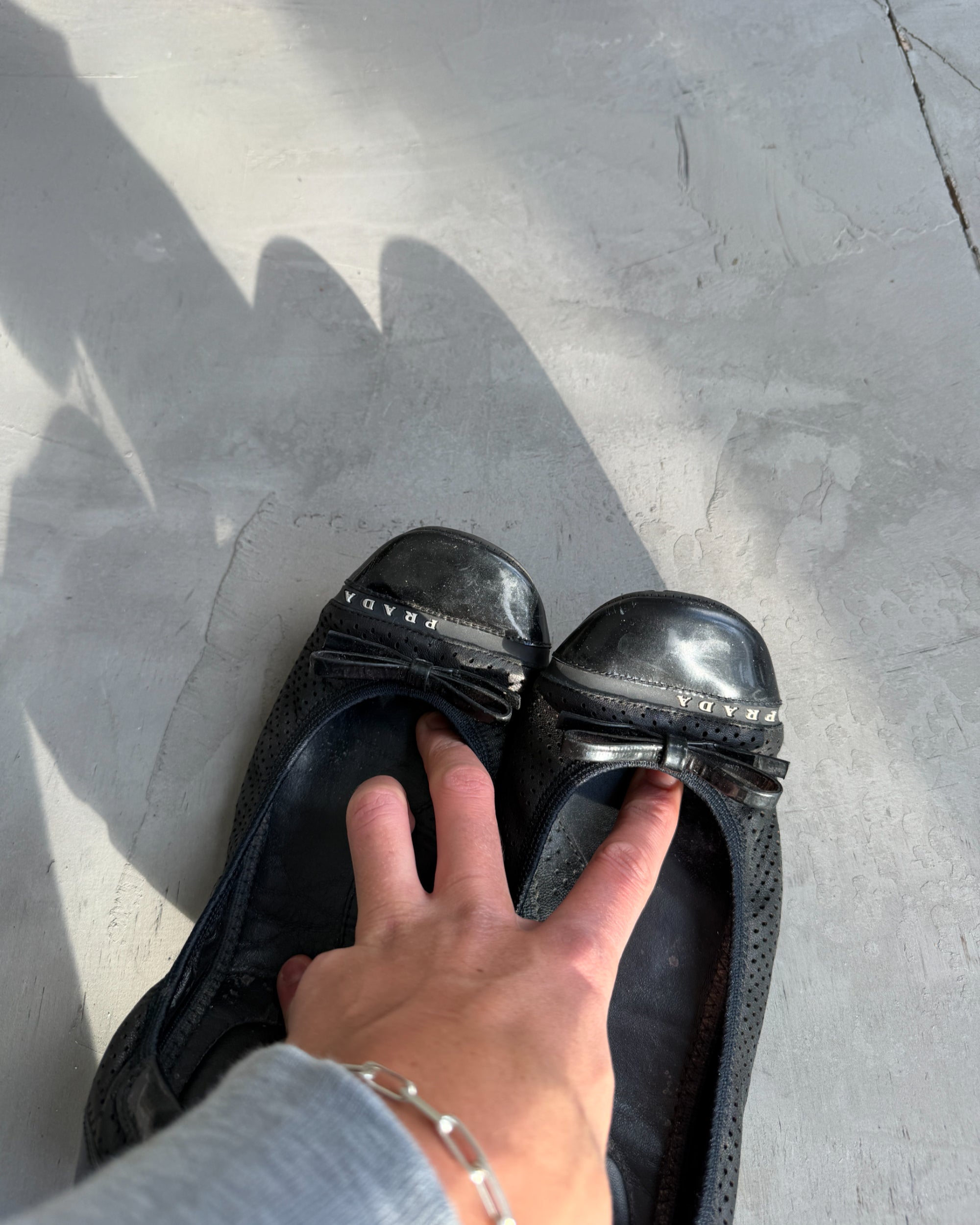 Prada Black Ballet Flats – EU 39-on a concrete background