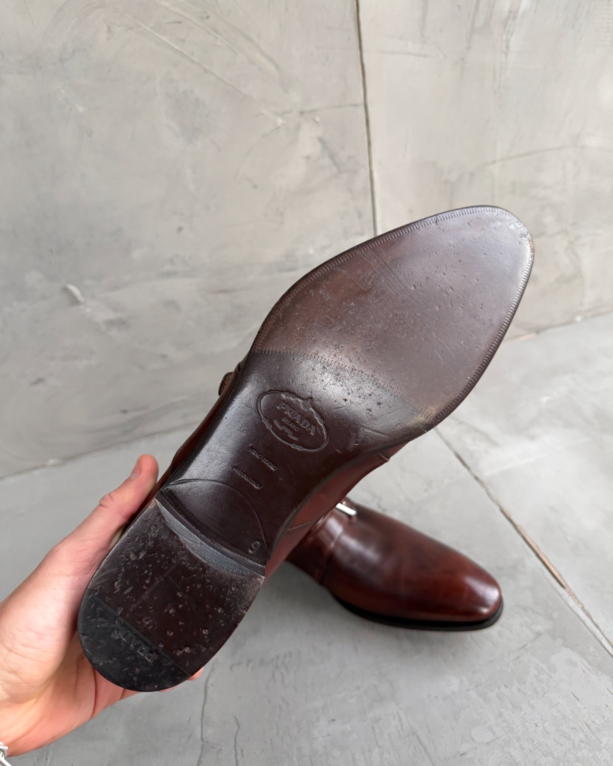 Prada Buckle Leather Derbys – UK 9-on a concrete background