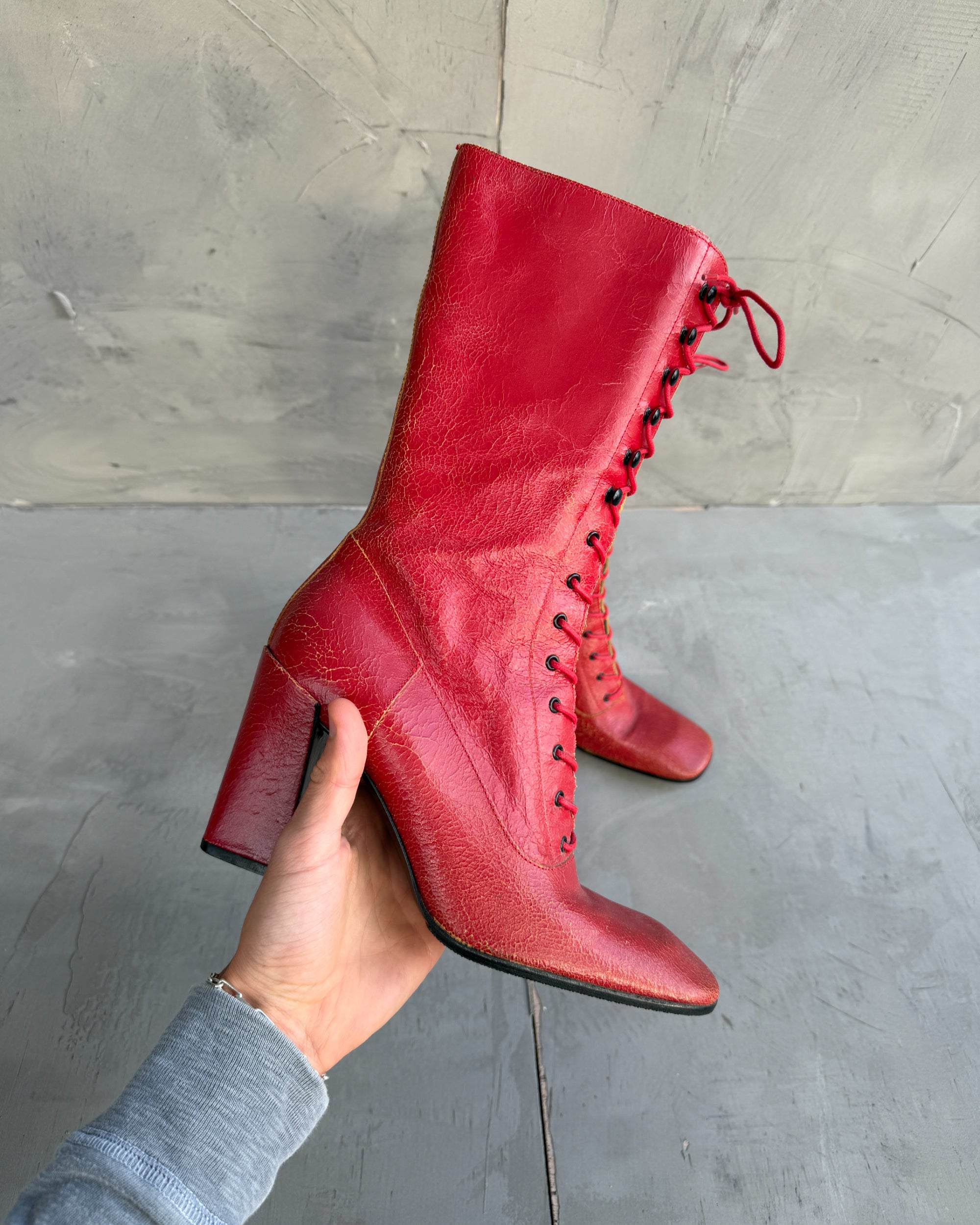 Miu Miu FW01 Cracked Leather Red Lace-Up Boots – EU 38-on a concrete background