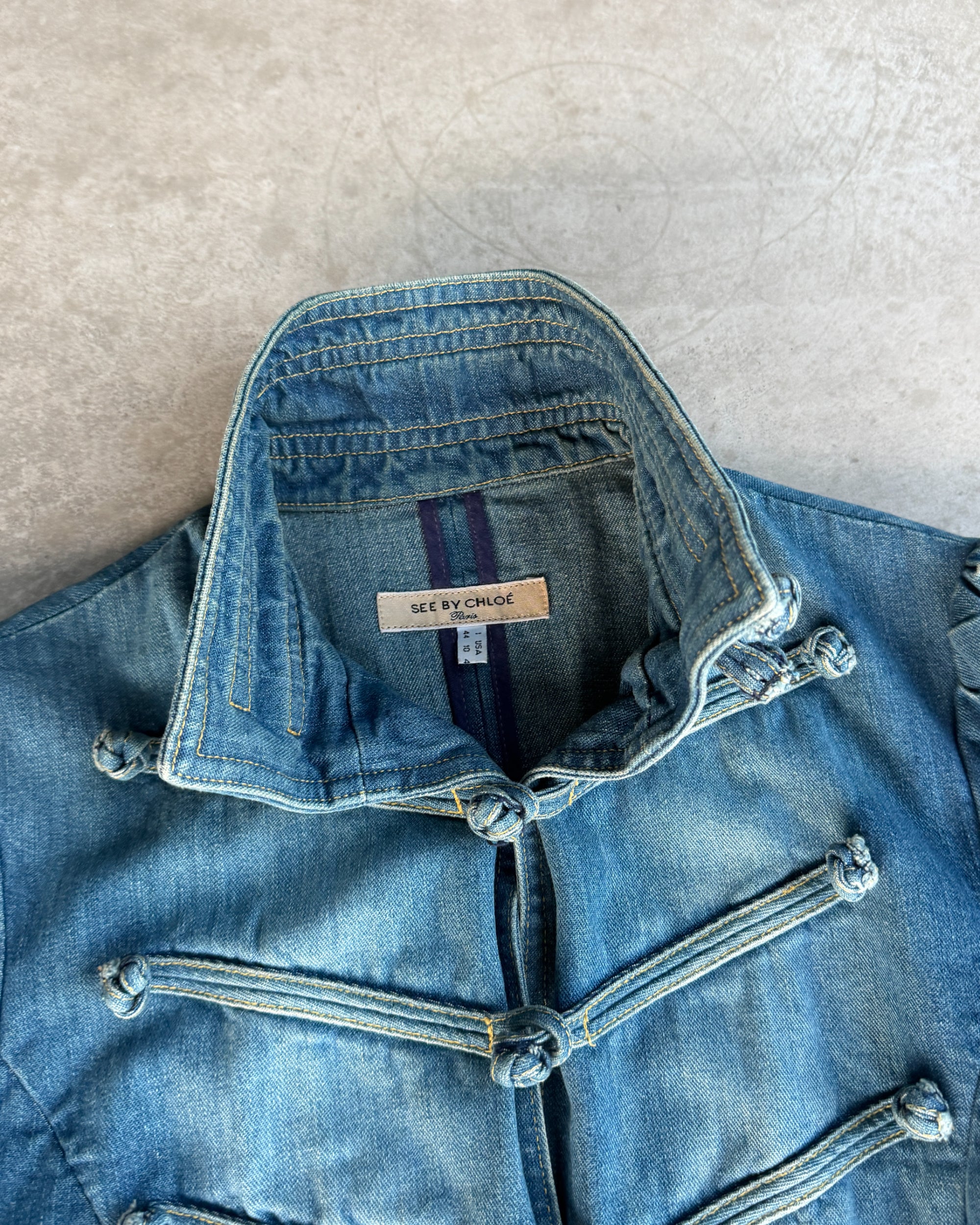 See by Chloé Hussar Denim Jacket – L-on a concrete background
