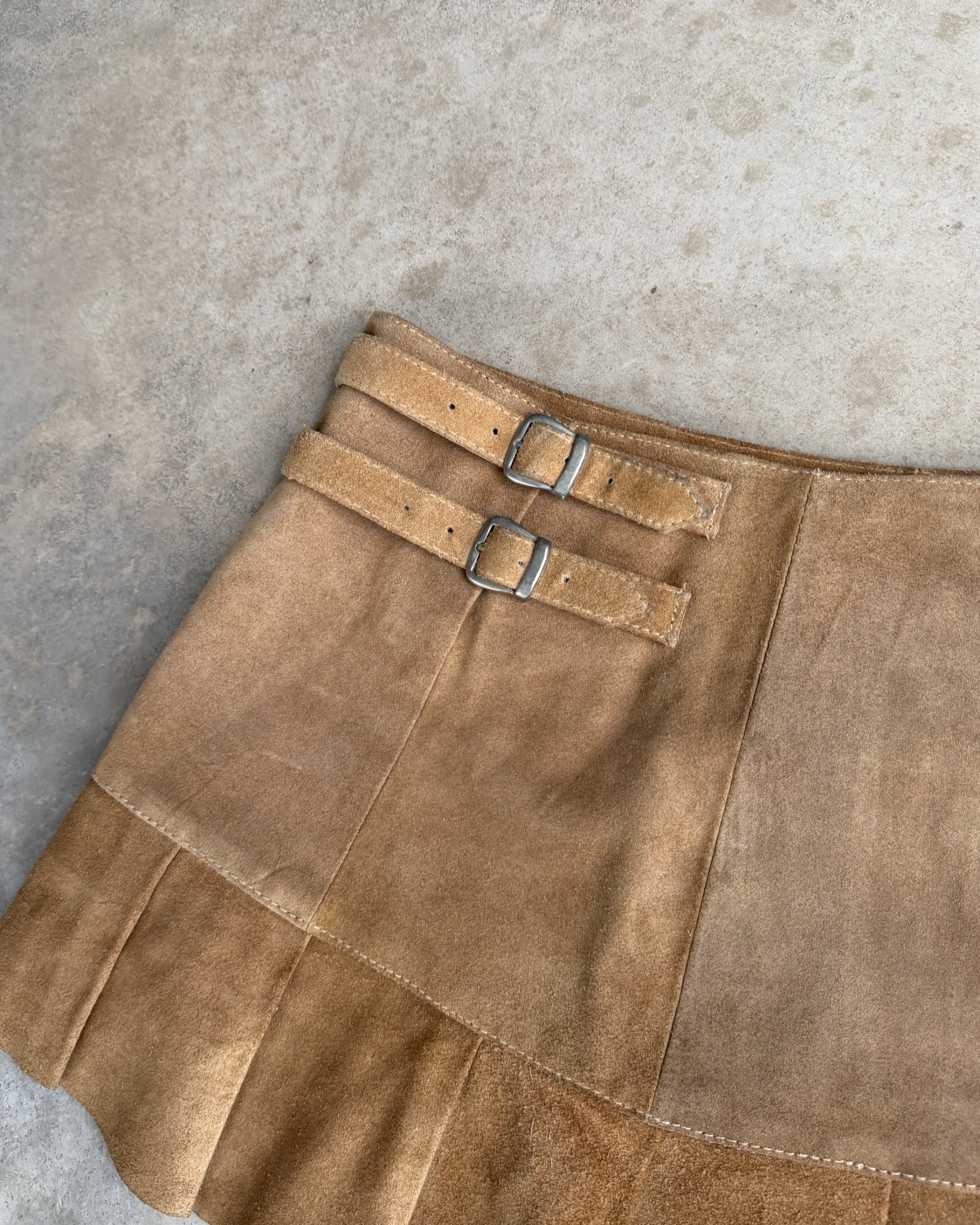 Leather Belted Mini Skirt – M-on a concrete background