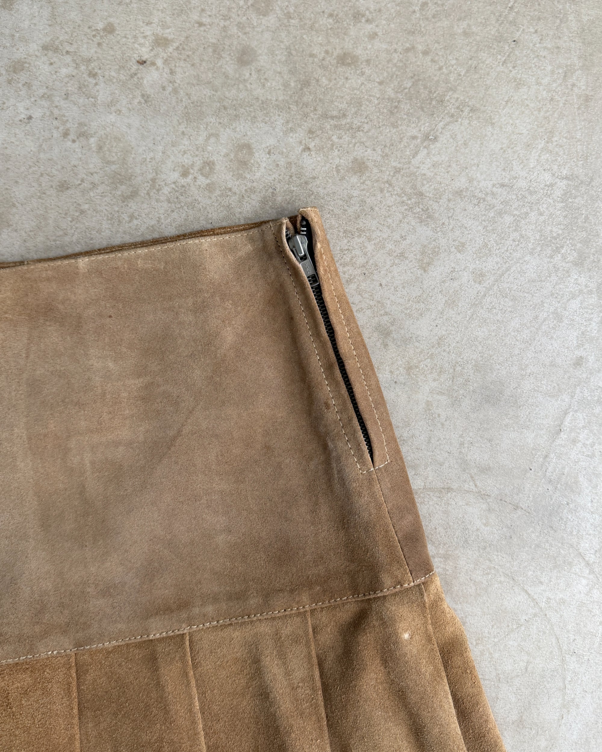 Leather Belted Mini Skirt – M-on a concrete background