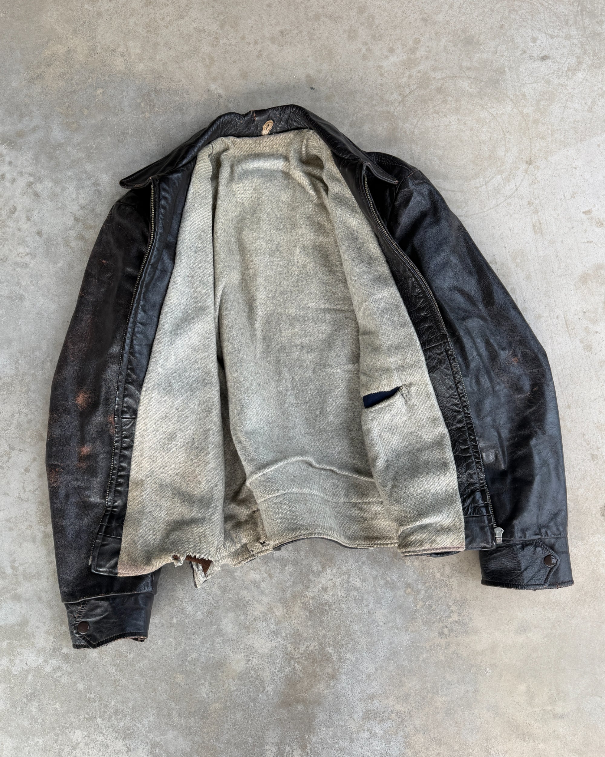 1970s Vintage Leather Jacket with Wool Lining – S-on a concrete background