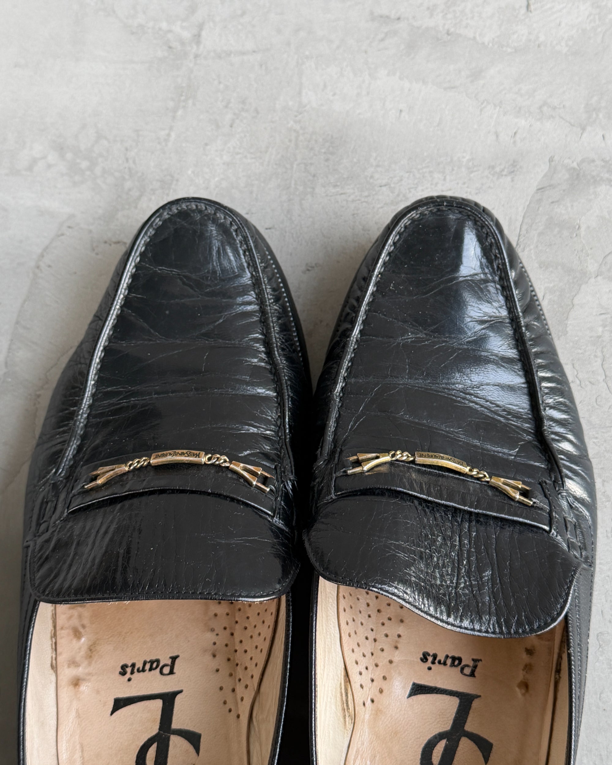 Yves Saint Laurent Black Leather Loafers – UK 8-on a concrete background