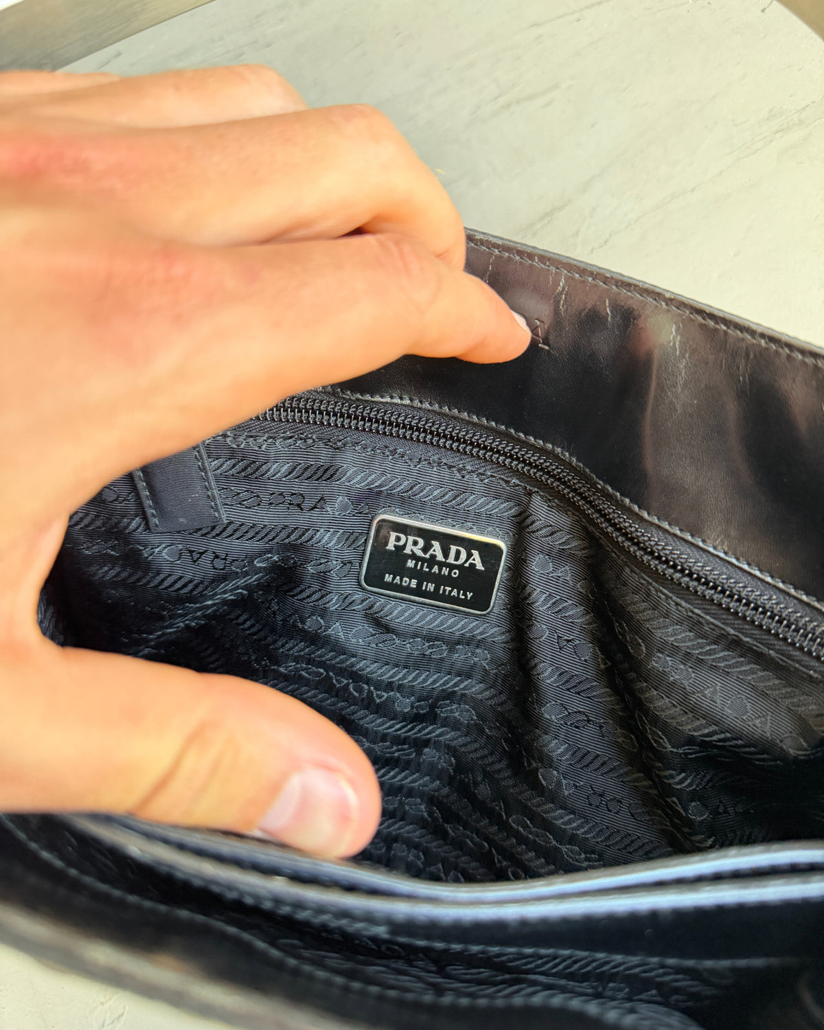 Prada Black Nylon and Leather Shoulder Bag-on a concrete background