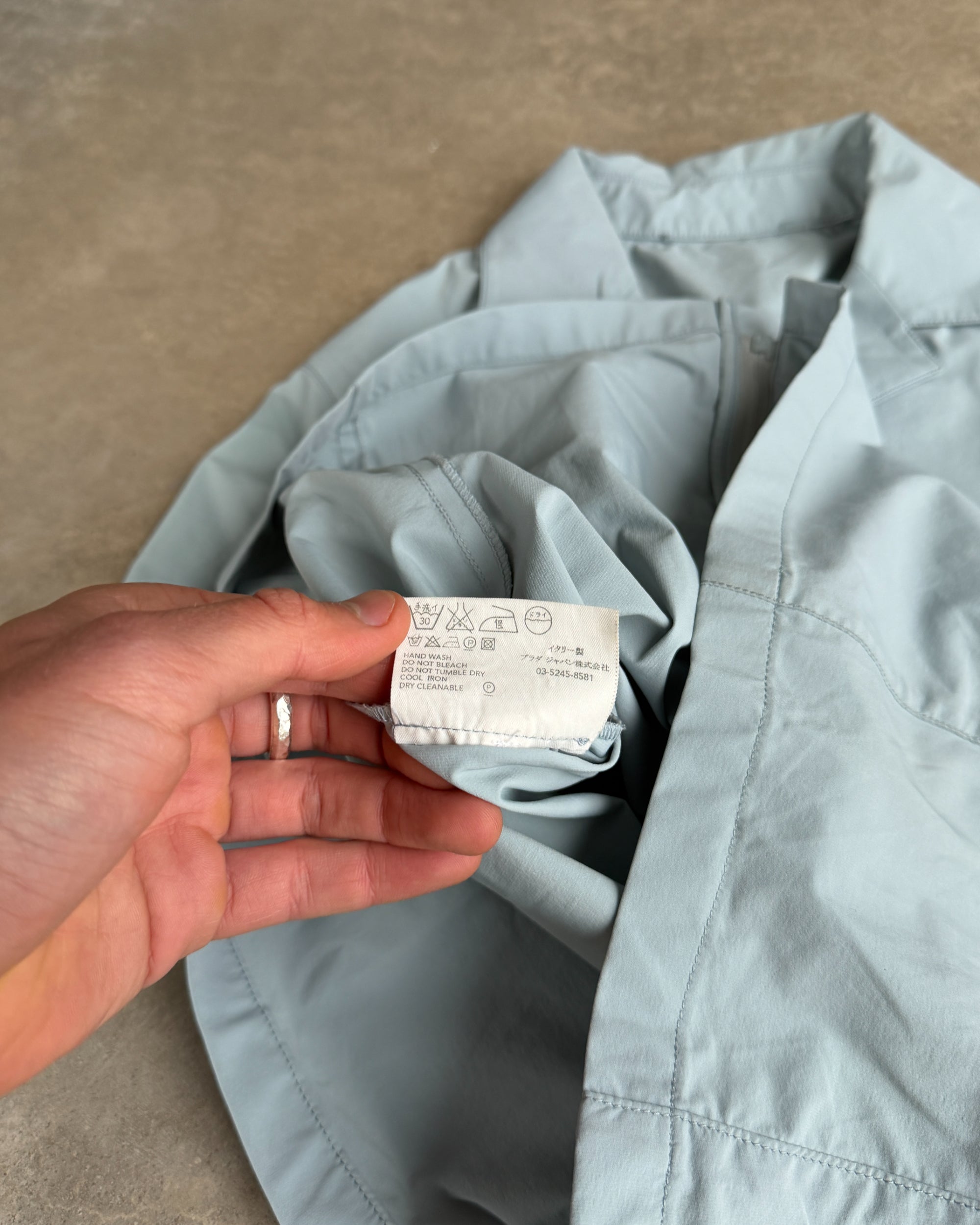 Prada SS99 Belted Nylon Short Sleeve Shirt – S-on a concrete background