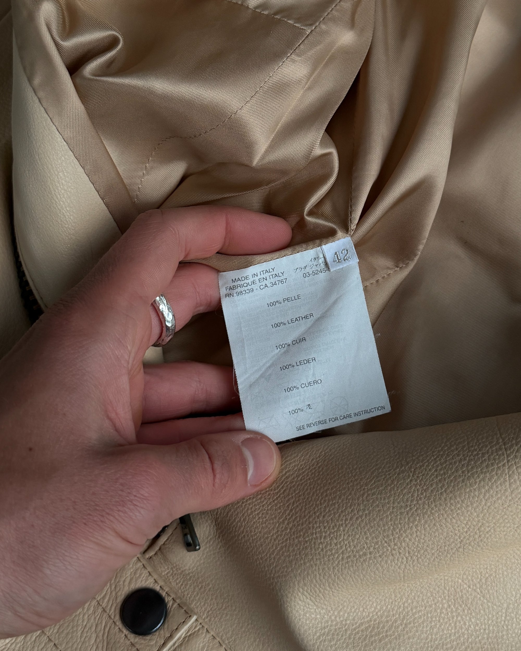 Prada Beige Leather Belted Jacket – M-on a concrete background