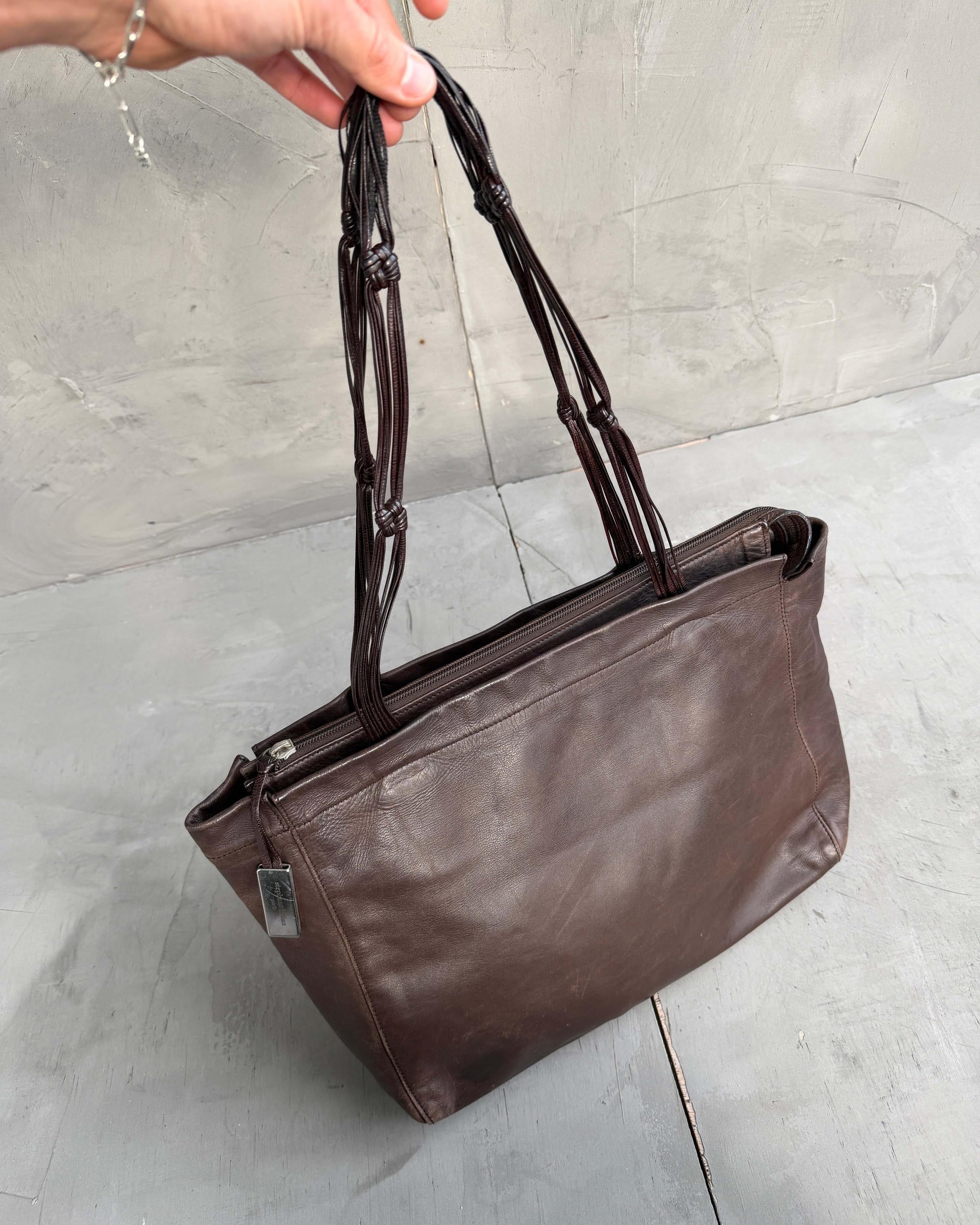 Stephane Kellan Leather Tote Bag-on a concrete background