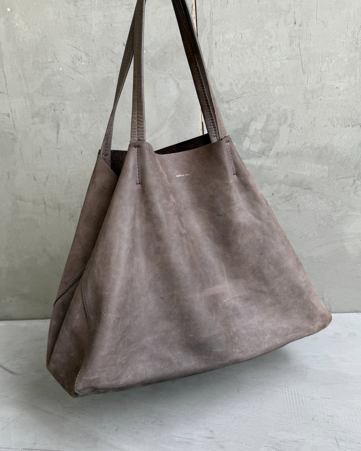Celine Brown Leather Tote Bag-on a concrete background