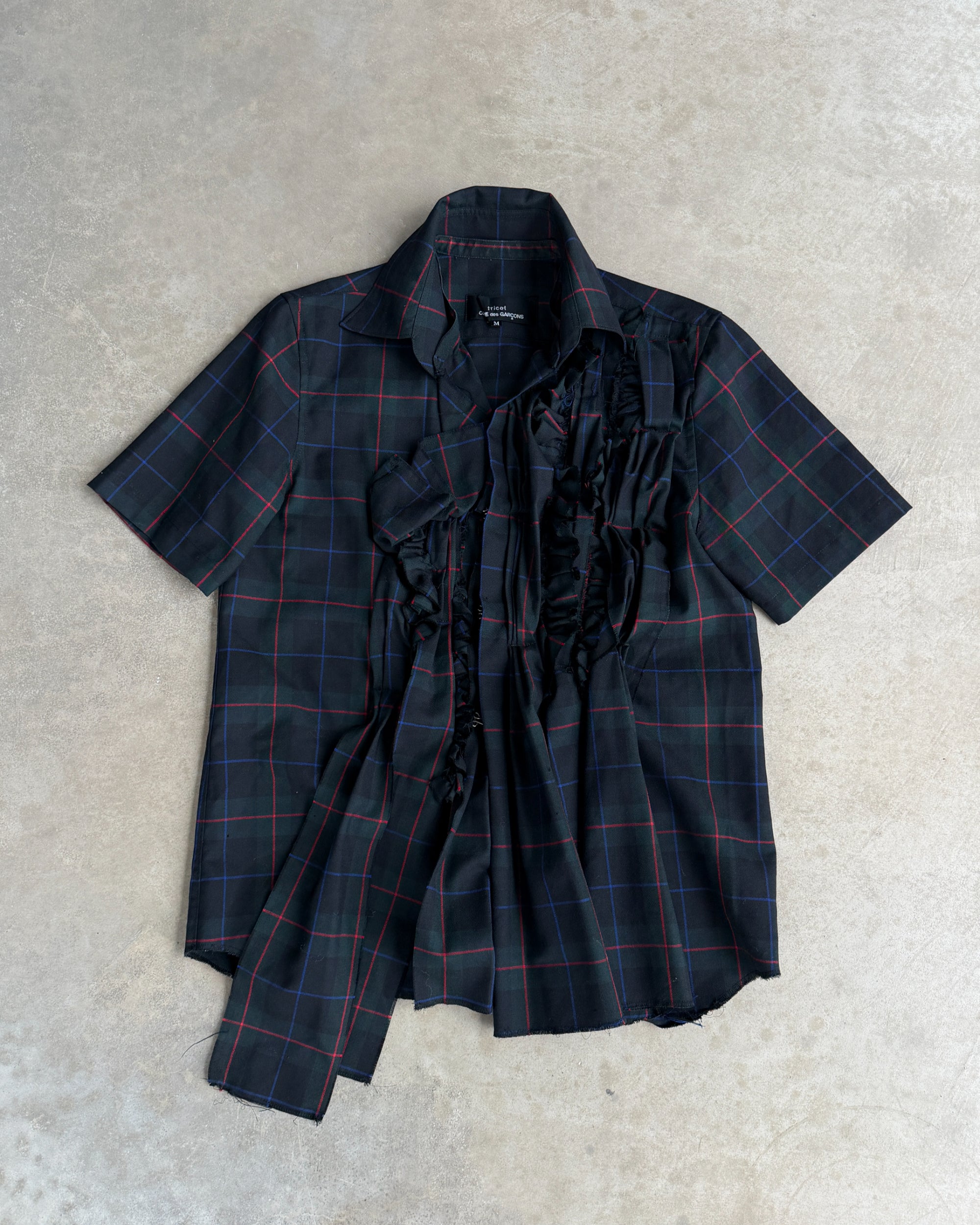 Comme des Garçons Tricot AW04 Checkered Short Sleeve Shirt – M-on a concrete background