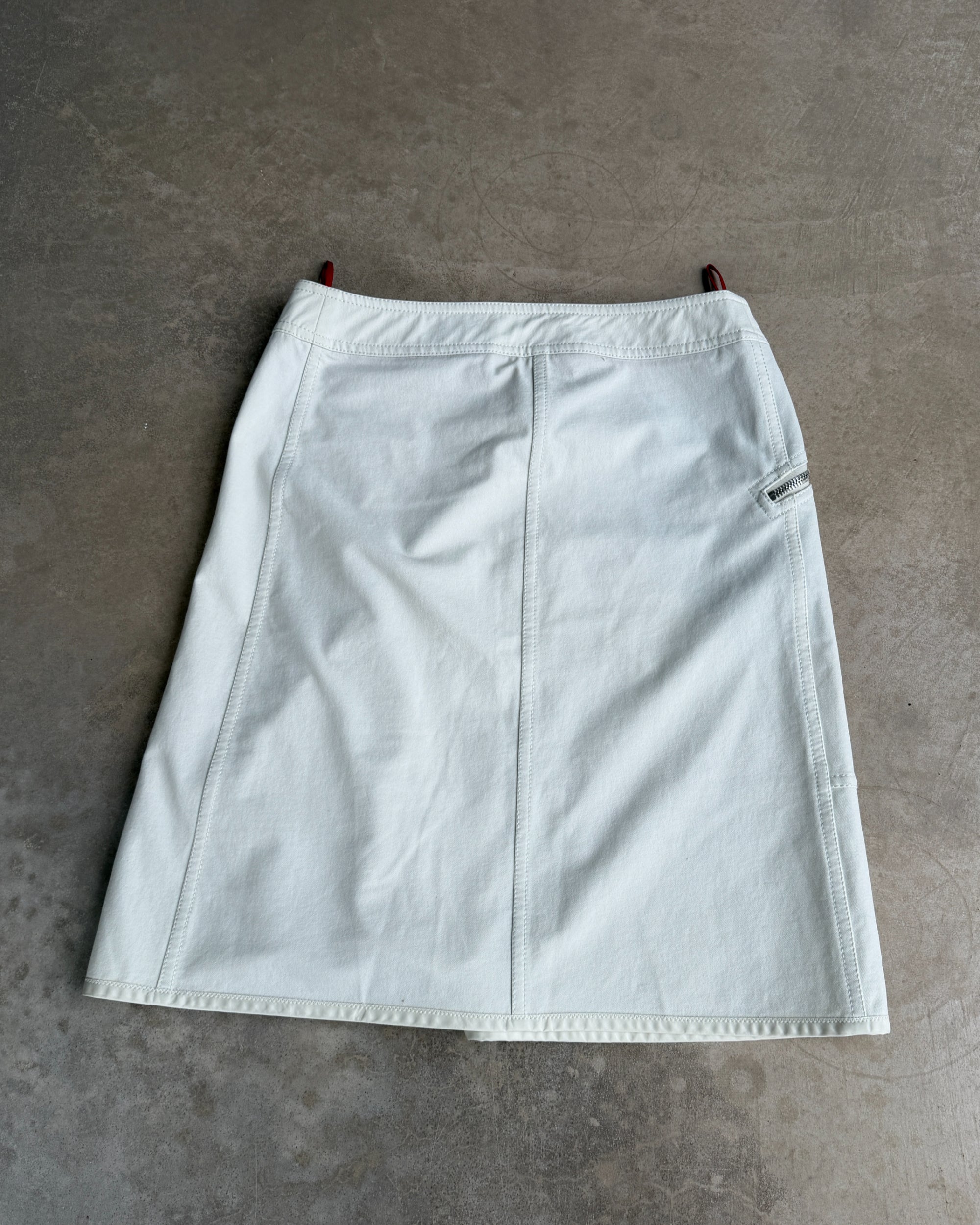Prada Sport Triple Belted Wrap Midi Skirt – L-on a concrete background