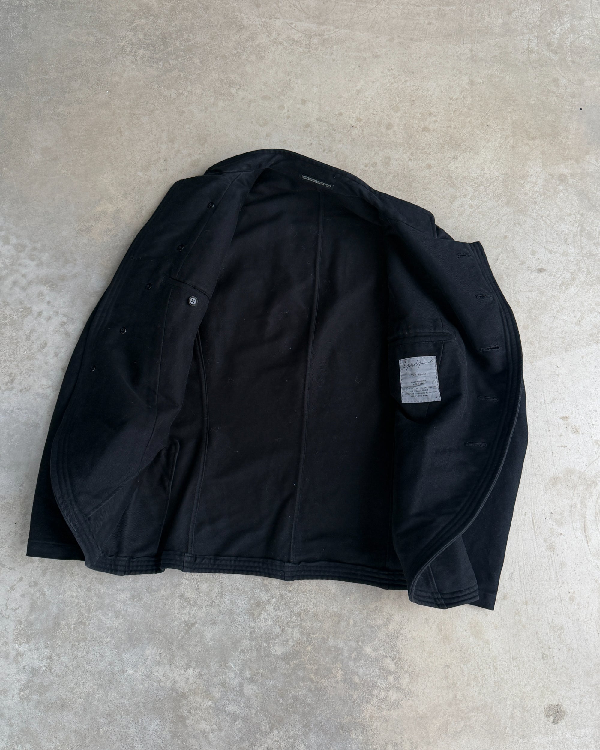 Yohji Yamamoto AW06 Asymmetric Cotton Jacket – S-on a concrete background