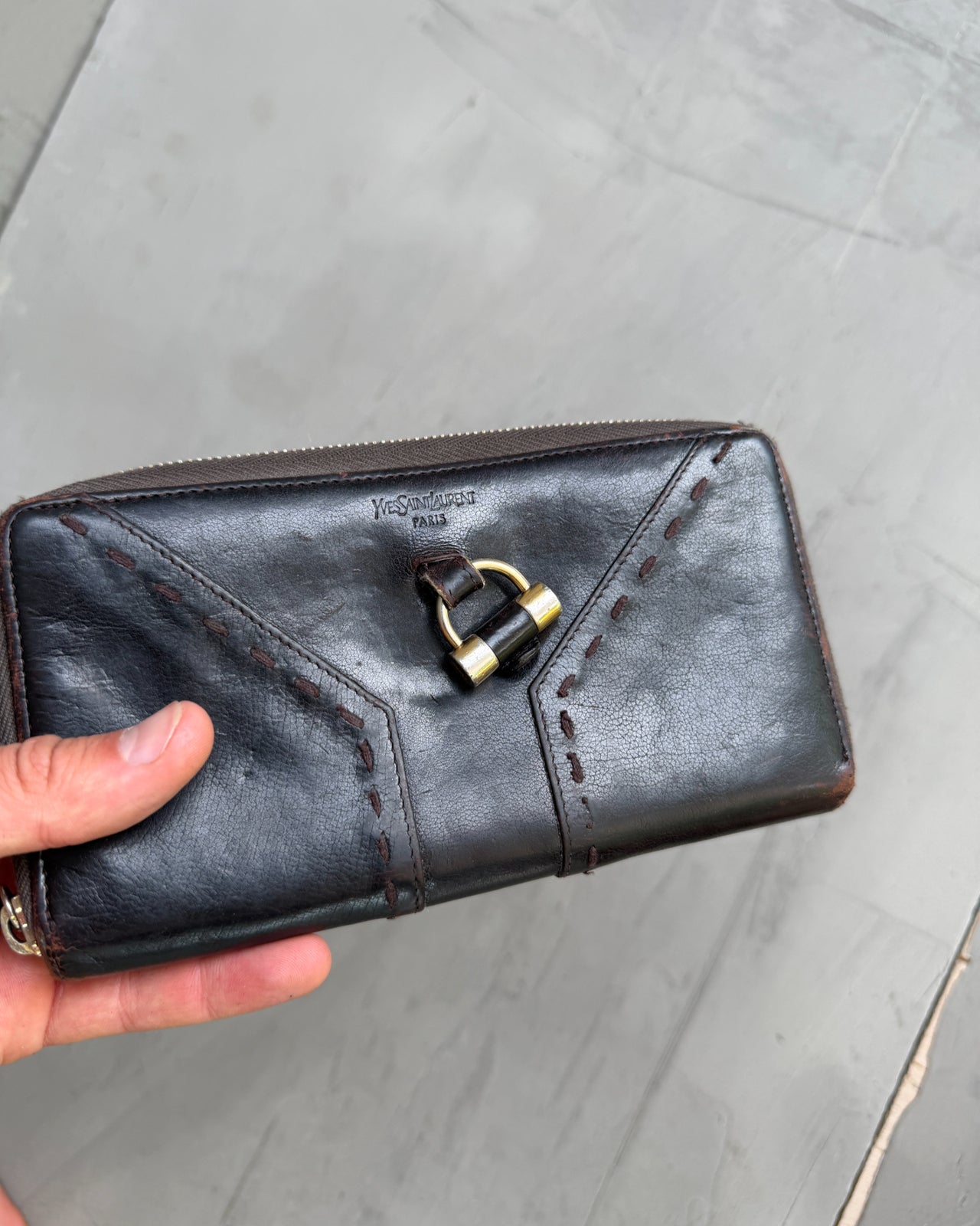 Yves Saint Laurent Leather Wallet-on a concrete background