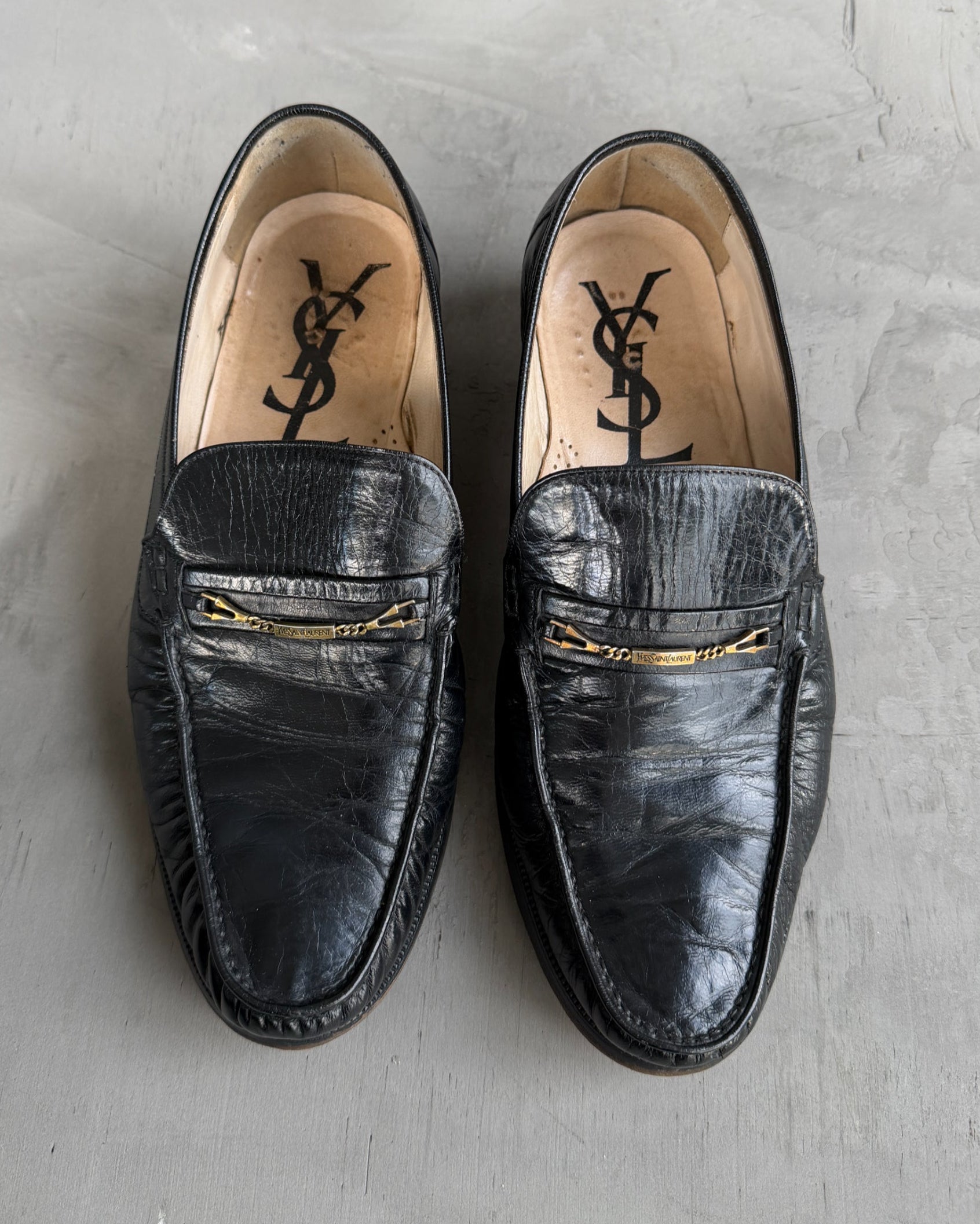 Yves Saint Laurent Black Leather Loafers – UK 8-on a concrete background