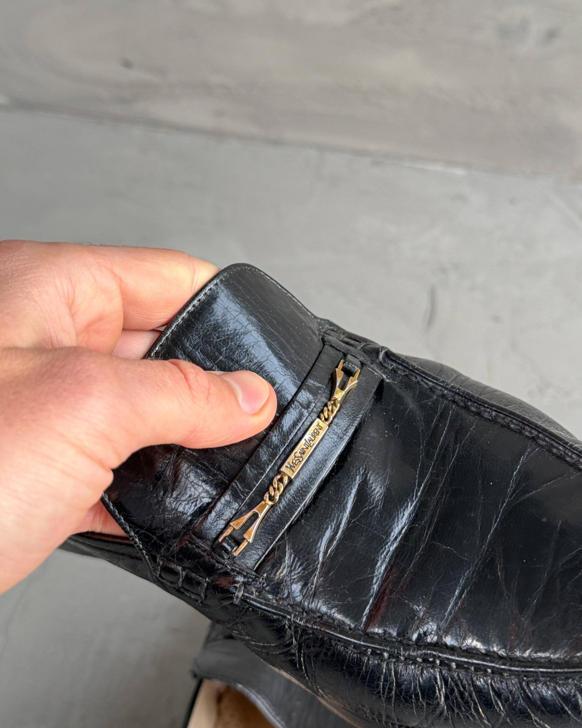 Yves Saint Laurent Black Leather Loafers – UK 8-on a concrete background