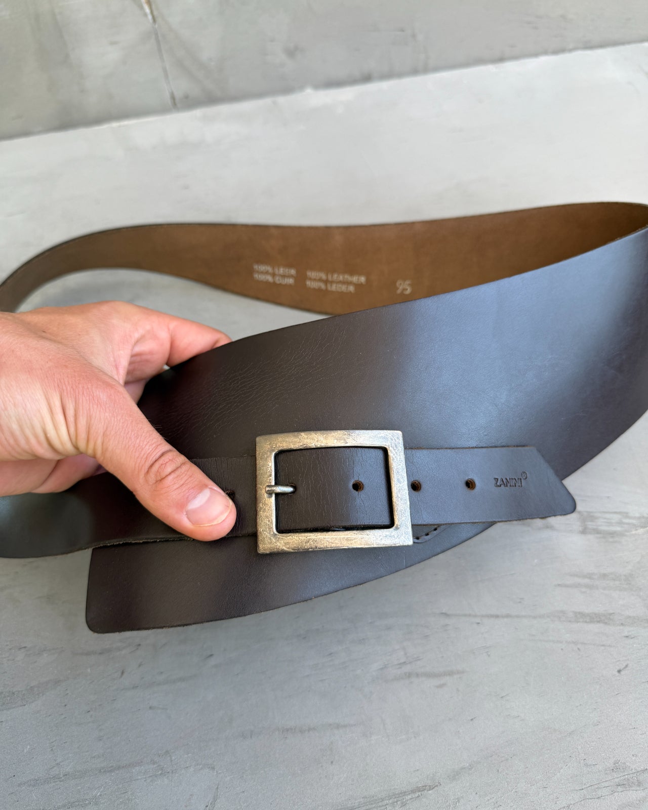 Zanini Oversized Brown Leather Belt-on a concrete background