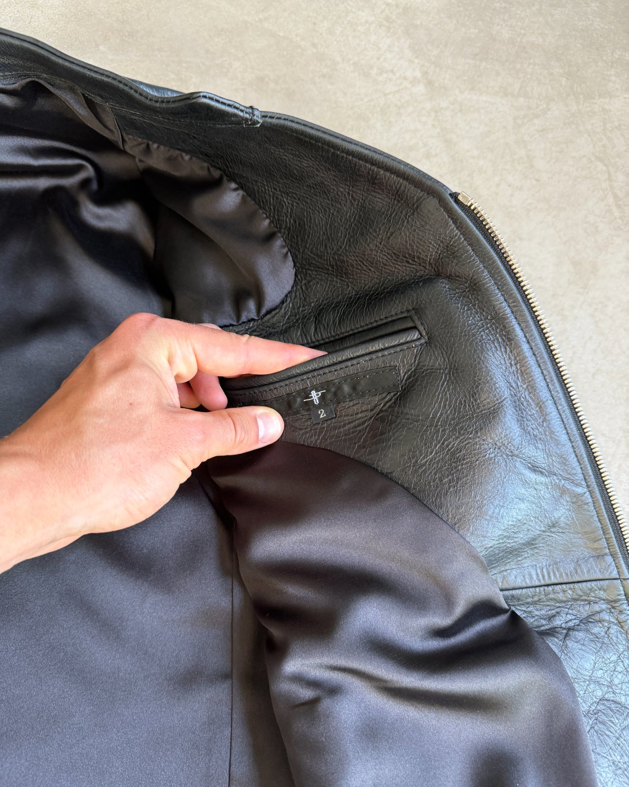 Japanese Black Leather Jacket – M-on a concrete background