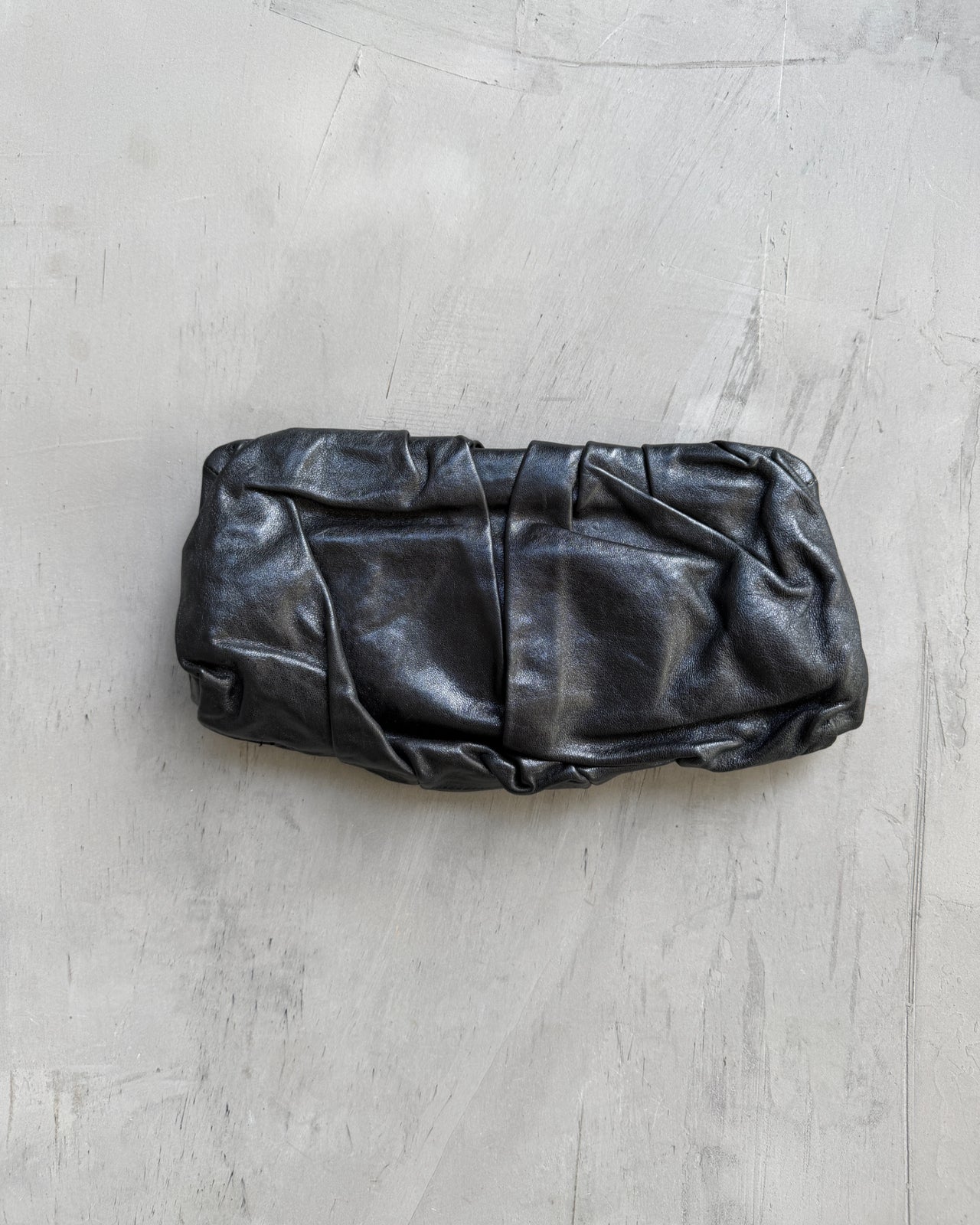 Giorgio Armani Pleated Leather Clutch Bag-on a concrete background