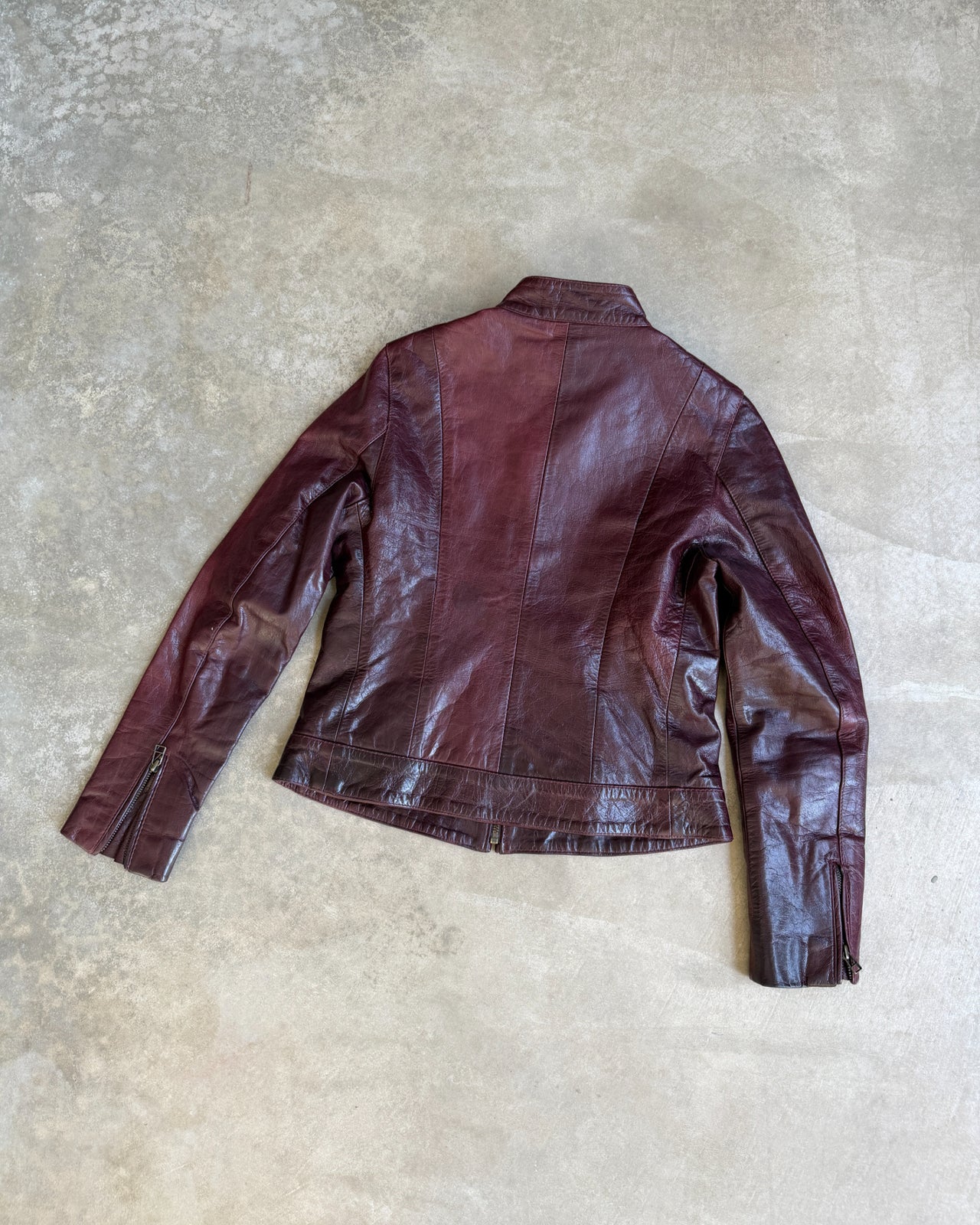 Transmission New York Oxblood Red Leather Jacket – L-on a concrete background