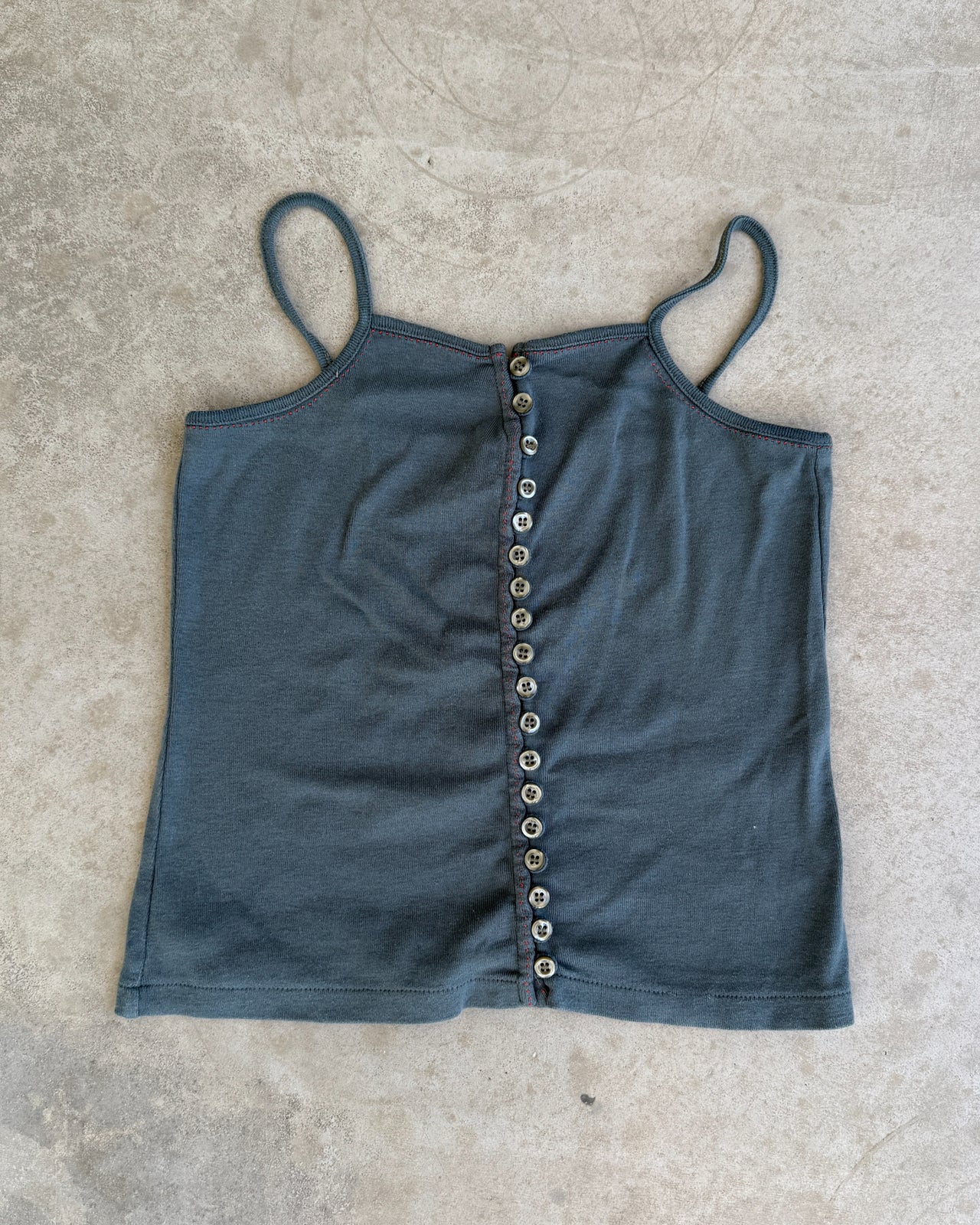 CFK Button Up Vest Top – XS/S-on a concrete background