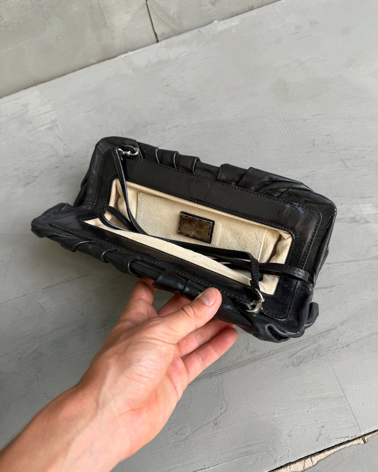 Giorgio Armani Pleated Leather Clutch Bag-on a concrete background