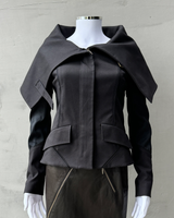 a photo of a gucci by tom ford fw 2003 asymmetric jacket, with a high neck collar and corseted waist. Tom ford gucci 2003