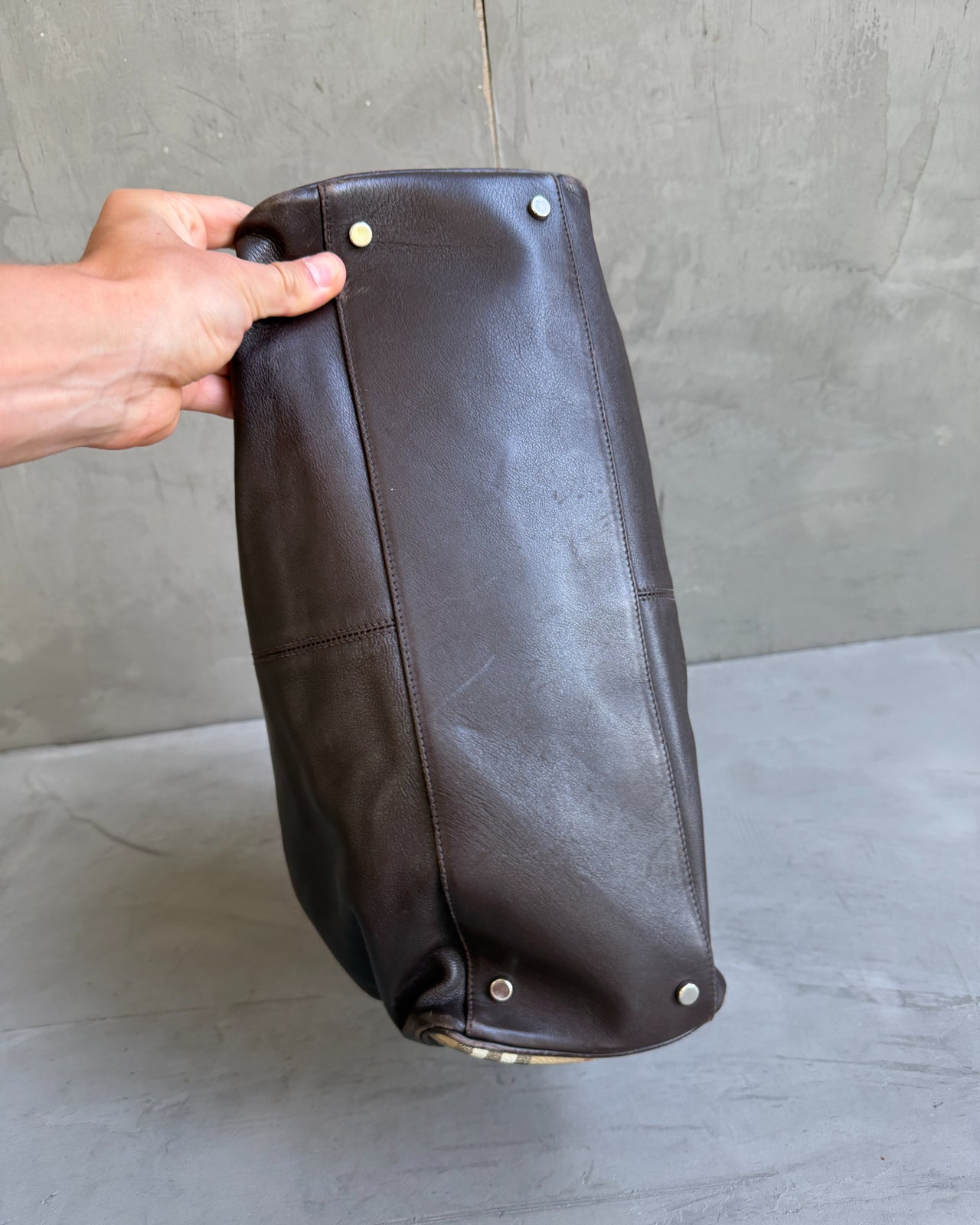 Burberry Dark Brown Leather Handbag-on a concrete background