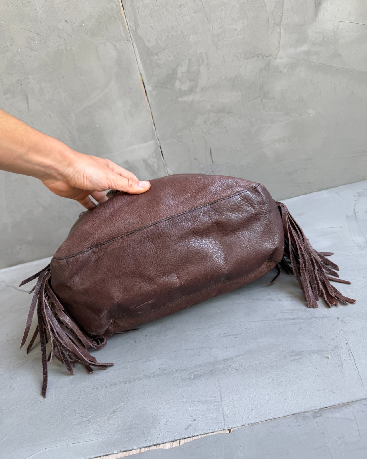 Ralph Lauren Brown Leather Fringe Shoulder Bag-on a concrete background