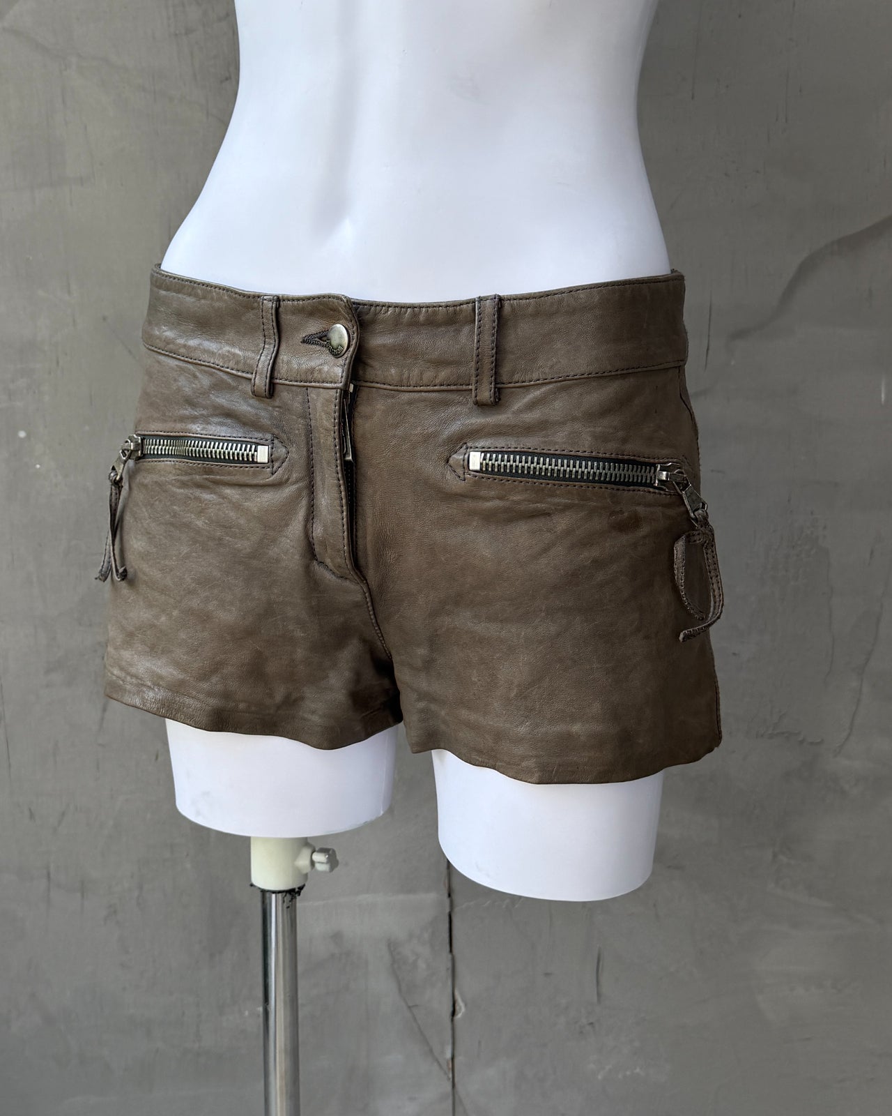 Just Cavalli Brown Leather Mini Shorts – S-on a concrete background