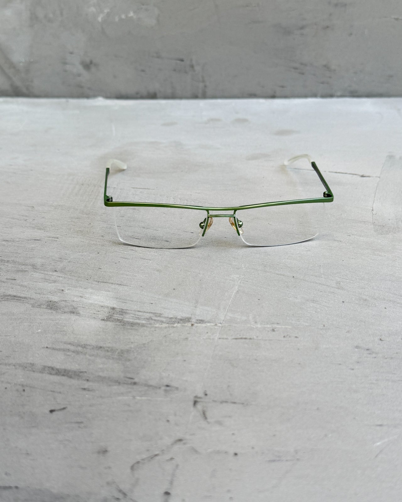 Max Mara Clear Lens Rimless Glasses-on a concrete background
