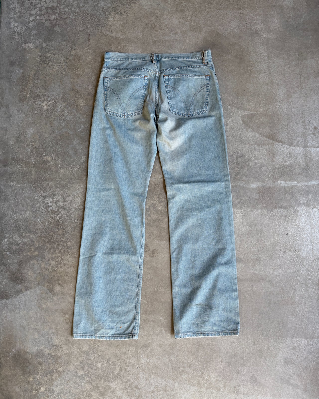 Dolce & Gabbana Light Blue Distressed Wide Leg Jeans with Leather Lace Up Fly – M-on a concrete background